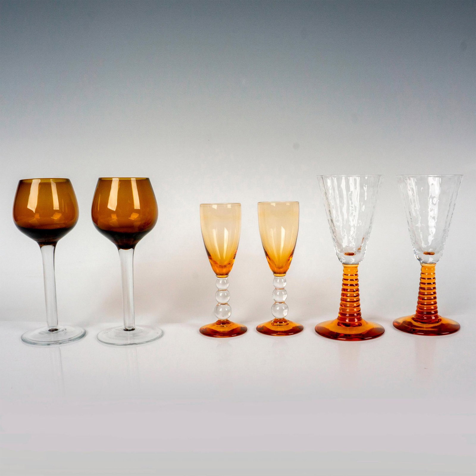6pc Cordial Glasses, Shades of Amber: Six attractive cordial glasses in varying shades of dark orange and brown. The largest pair is 5.25"H x 2.25"dia.