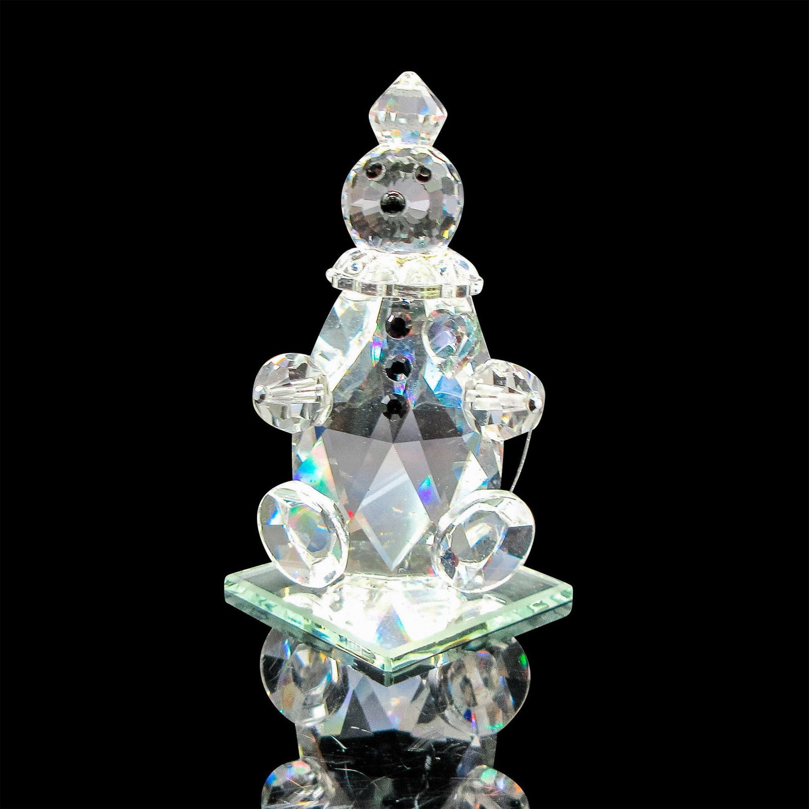 Vintage Crystal Figurine, Sitting Clown: Faceted body, head and feet seated on mirror pane. Black crystal eyes, nose and buttons. Dimensions: 1.25"L x 1.25"W x 2.25"H
