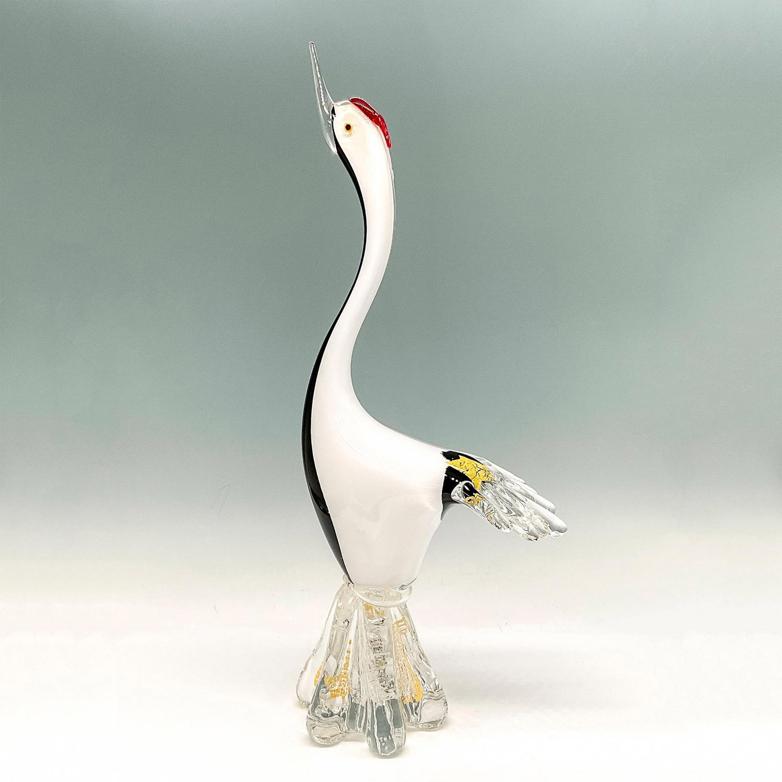 Art Glass Sculpture, Red Crowned Crane: This elegant sculpture was created by blending white, black and clear glass with red glass on head and gilt accents to highlight the design. Sturdy clear ripple design on base. Issued: 20th century Di