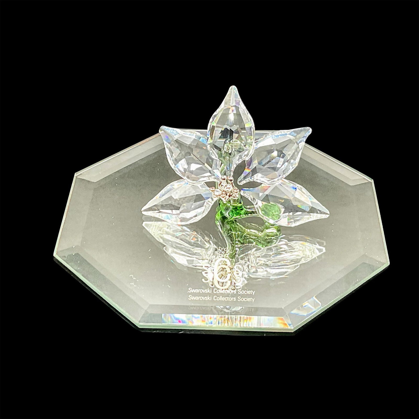 Swarovski SCS Crystal Figurine, Orchid Paperweight + Mirror Base: Lead crystal orchid flower with silver tone metal center. Exclusively crafted for SCS joined or renewed membership. Swarovski etched backstamp. This item has its original box which measures: 3.75"L x 