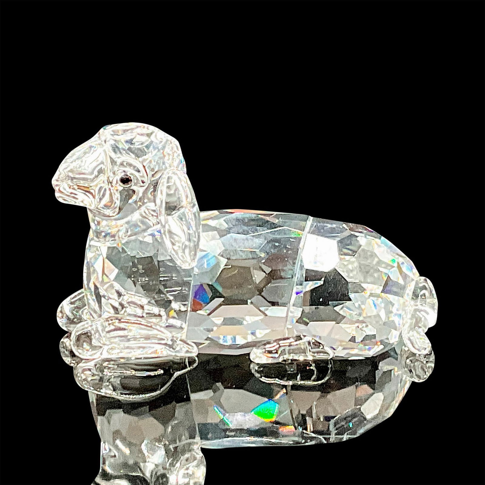 Swarovski Crystal Figurine, Sheep Mother Reclining: Part of the Peaceful Countryside group. Clear faceted body with jet crystal button eyes. Swarovski etched backstamp. Item number 631437. This item has its original box which measures 4.75"H x 2.25"dia