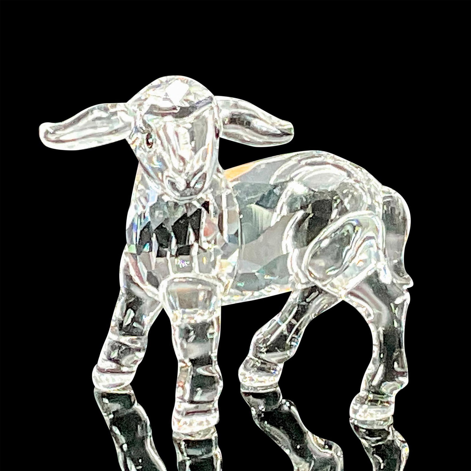Swarovski Crystal Figurine, Little Lamb: Part of the Peaceful Countryside collection. Lead clear crystal lamb with jet crystal eyes. Swarovski etched backstamp. This item has its original box which measures 3.25"W x 4.75"H. Artist: Edith Mai
