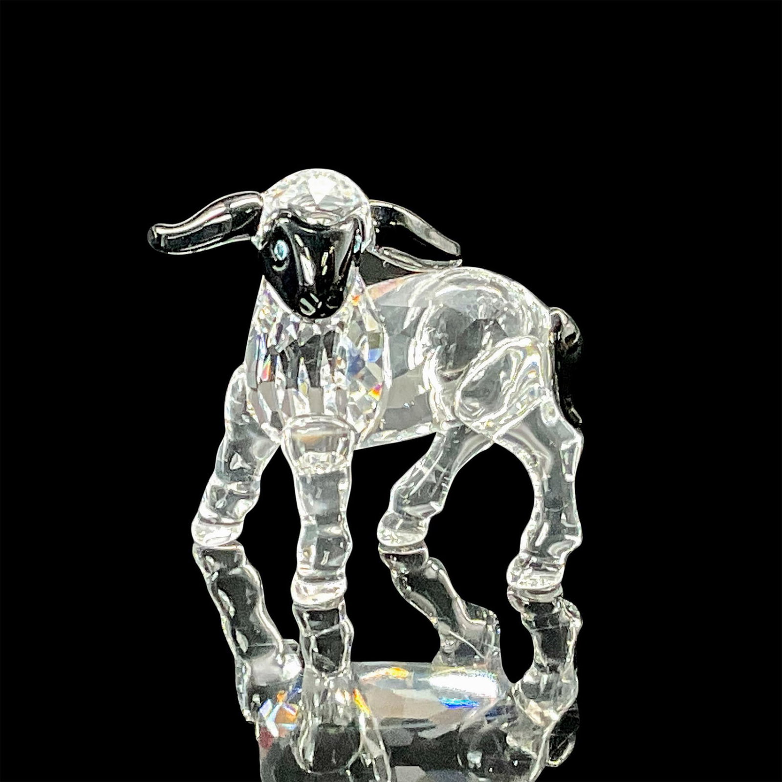 Swarovski Crystal Figurine, Little Lamb Black Ears and Face: Part of the Peaceful Countryside collection. Beautiful lead crystal small lamb with jet black ears, face and tail, with aquamarine eyes. Swarovski etched backstamp. This item has its original box whic