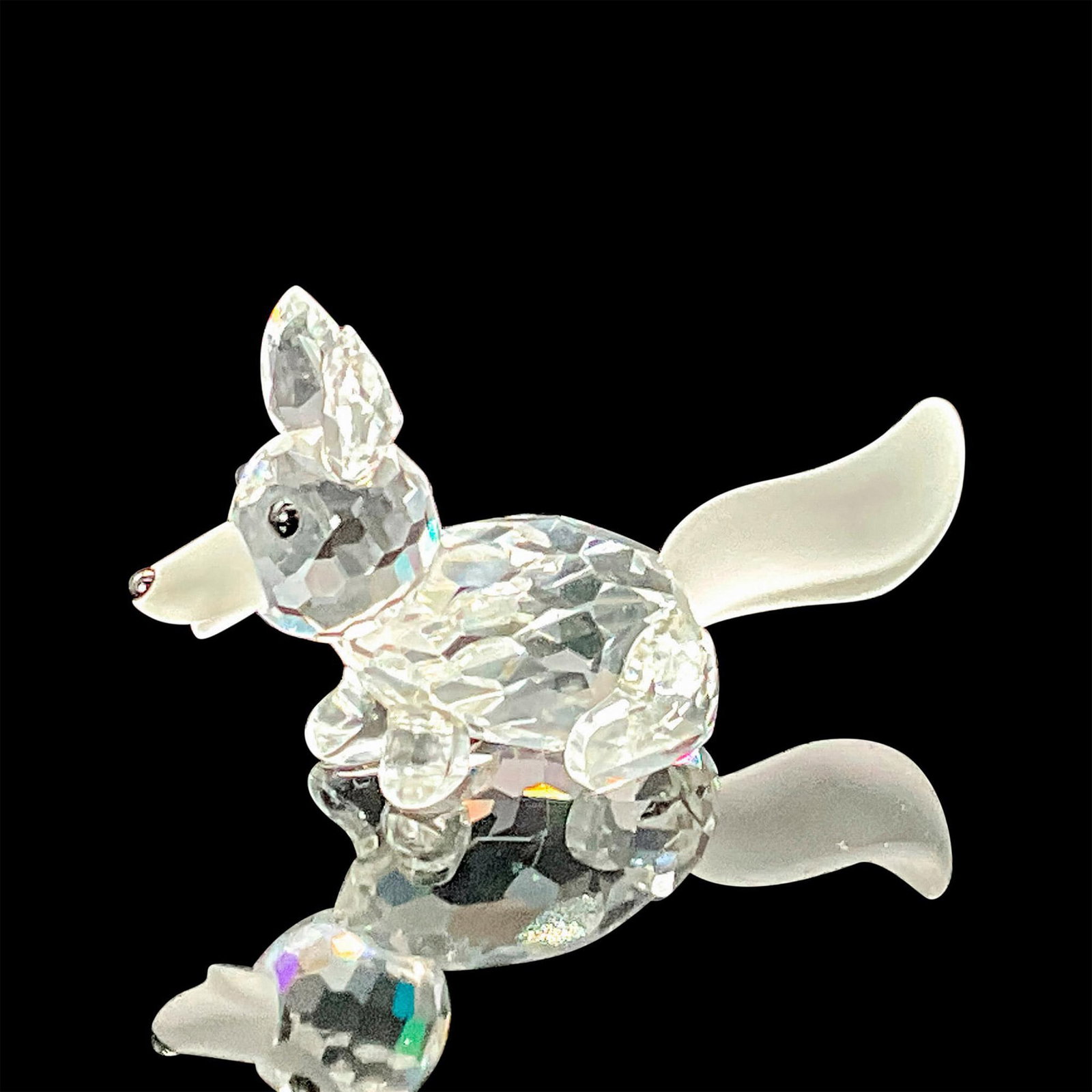 Swarovski Silver Crystal Figurine, Mini Fox Running: A clear faceted body of a fox running, with a frosted tail. Swarovski etched backstamp. This item has its original box which measures 3.25"W x 2.5"H. Artist: Adi Stocker Issued: 1988-1996 Dimensions: 