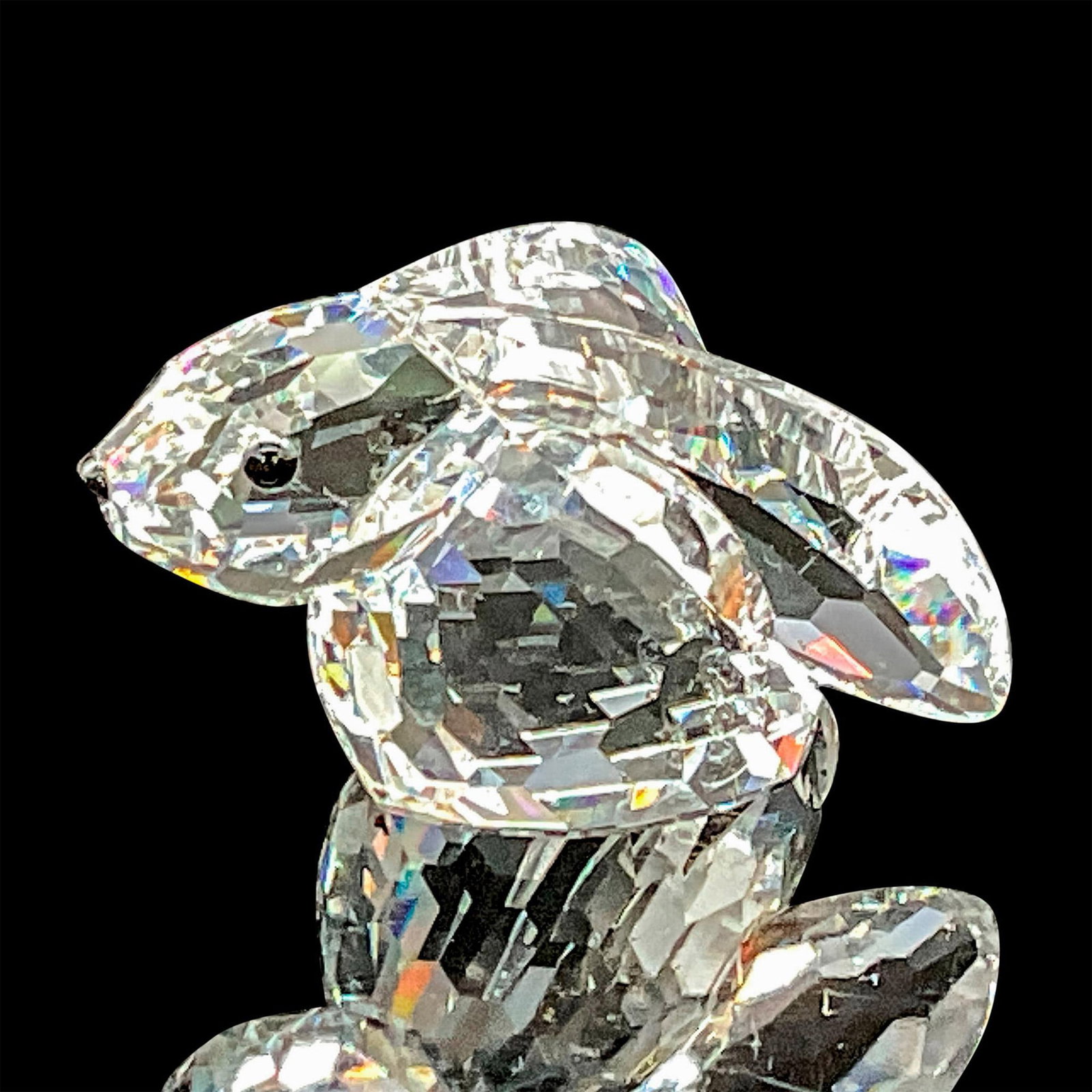 Swarovski Silver Crystal Figurine, Bunny Rabbit: This Swarovski crystal bunny rabbit was part of the In a Summer Meadow collection. He is made from clear faceted crystal and has very long ears. His eyes and nose are made from black crystal. Swarovsk