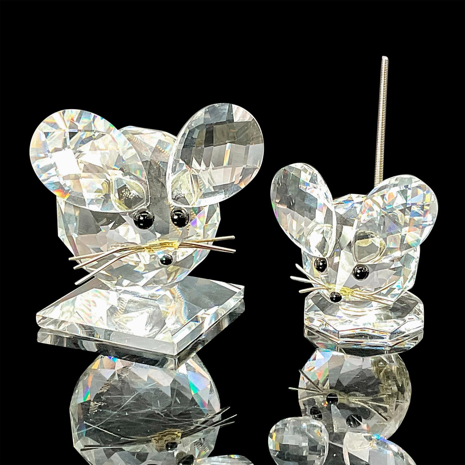 Pair of Swarovski Crystal Figurines, Mice: These Swarovski crystal mice were part of the In the Summer Meadow collection. They are made from clear crystal, with black eyes and nose, and has a metal spring coil tail. The ears are fully faceted 