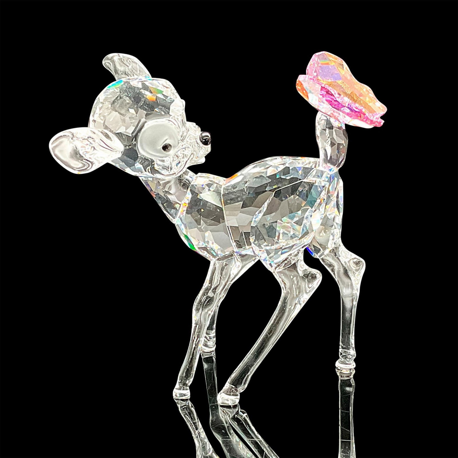 Swarovski Crystal Figurine, Bambi 943951: Disney Bambi collection. Clear faceted crystal body with aurora borealis rosaline butterfly on tail. 0Swarovski etched backstamp. This item has its original box which measures 6"L x 6"W x 4"H. Artist: