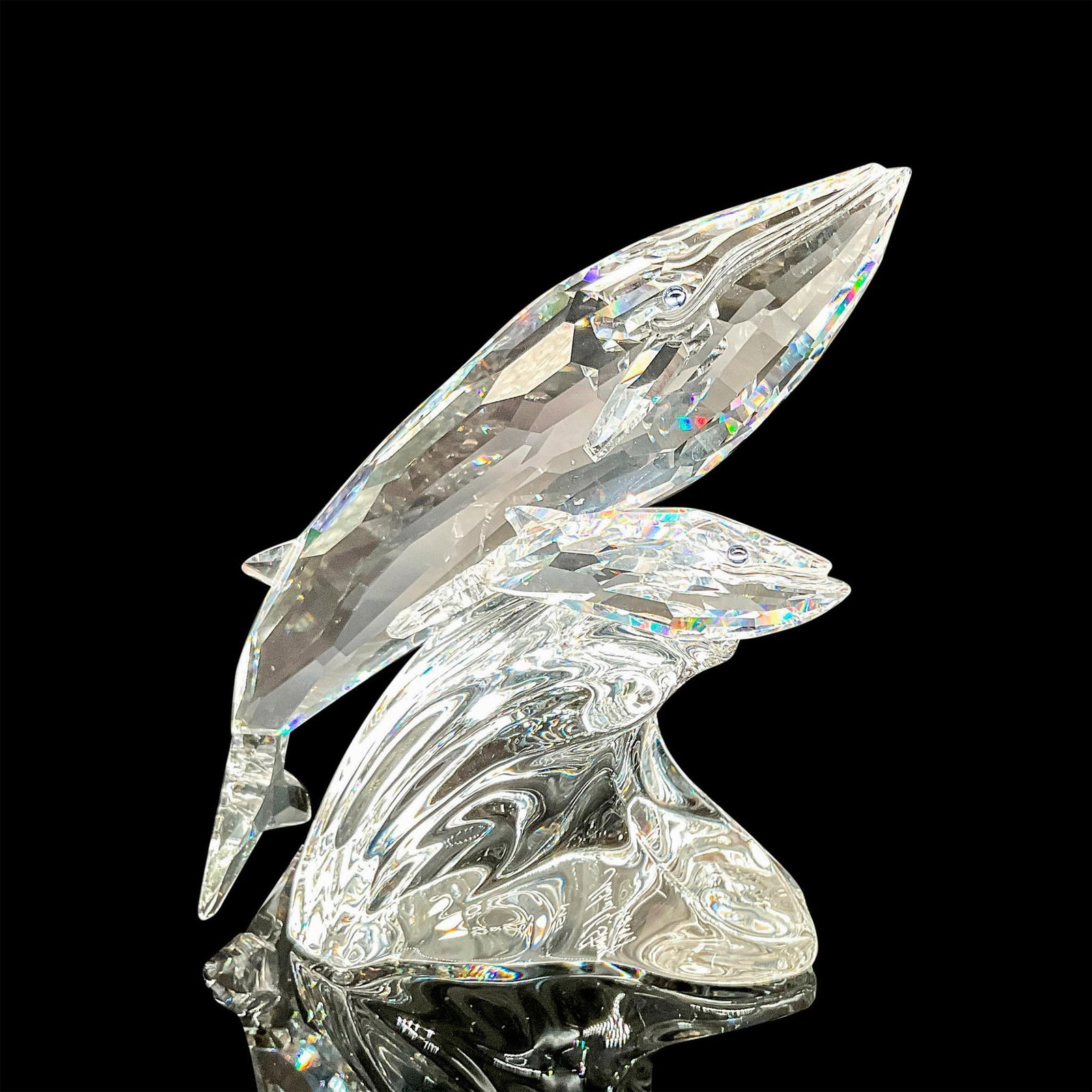 Swarovski Crystal Figurine, Care for Me - The Whales, Signed: Faceted crystal figurine modeled as a blue whale and her calf riding a wave. Part of the SCS Collection. Signed and dated by designer on base with Swarovski acid mark. Includes box, Box measurements: 