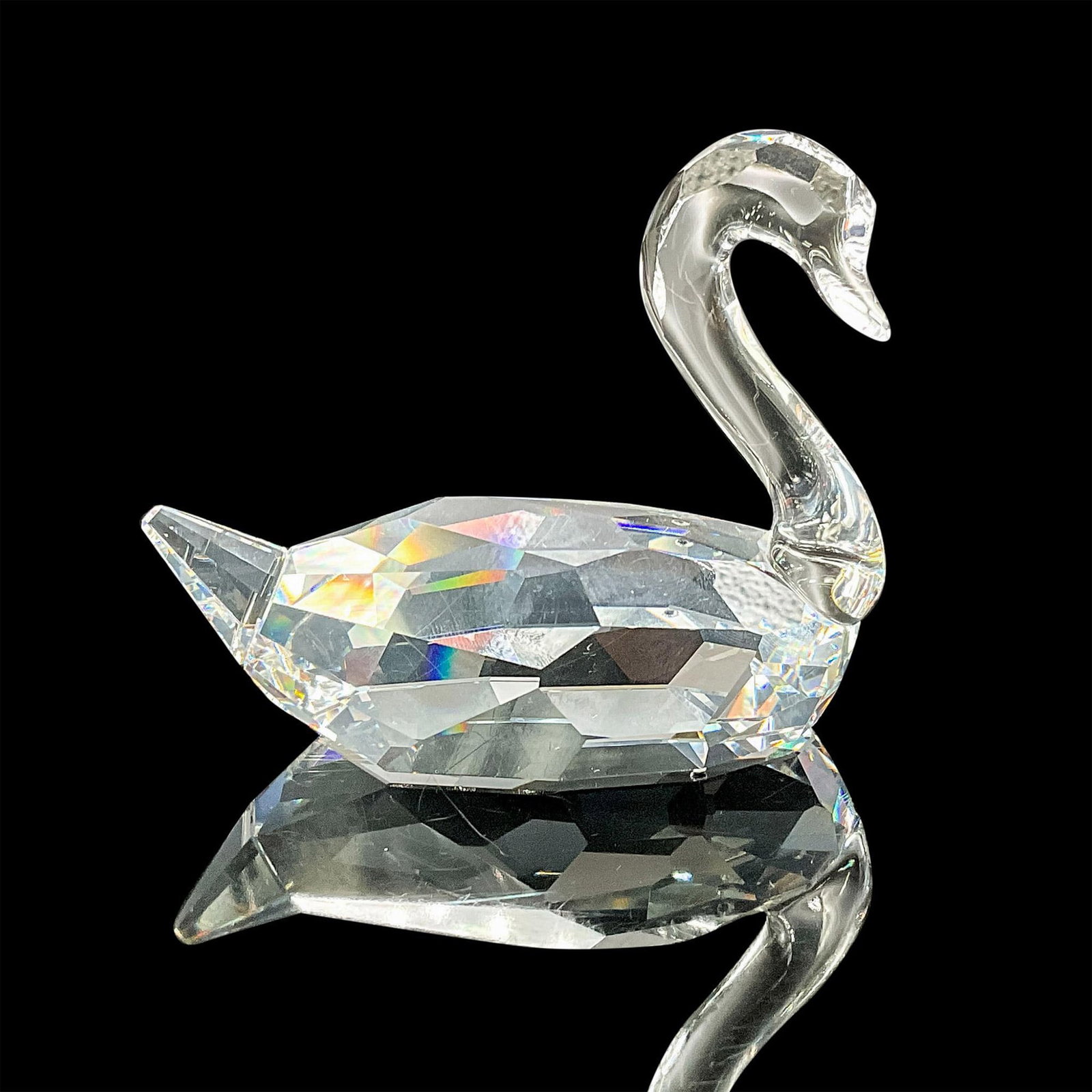 Swarovski Crystal Figurine, Swan Flirting Single: This Swarovski crystal flirting swan was part of the Feathered Beauties collection. Made in faceted clear crystal. The neck and beak are not faceted. Swarovski etched backstamp. This item has its orig