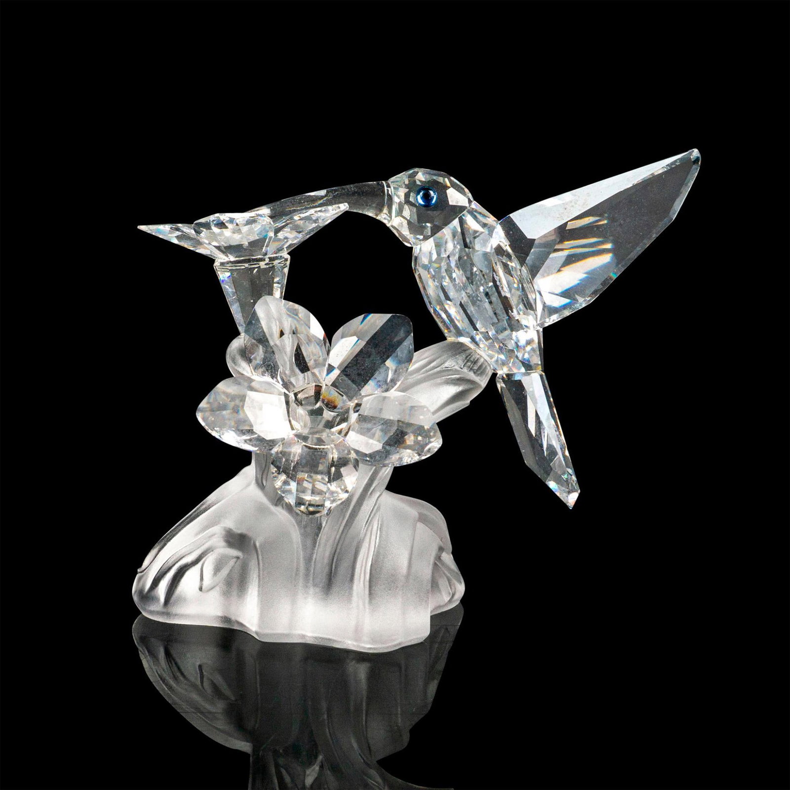 Swarovski Silver Crystal Figurine, Hummingbird: Lead crystal part of the Feathered Beauties collection and is made with frosted crystal base and jet crystal eyes. Swarovski etched backstamp. This item has its original box. Box measures: 6"W x 4.75"