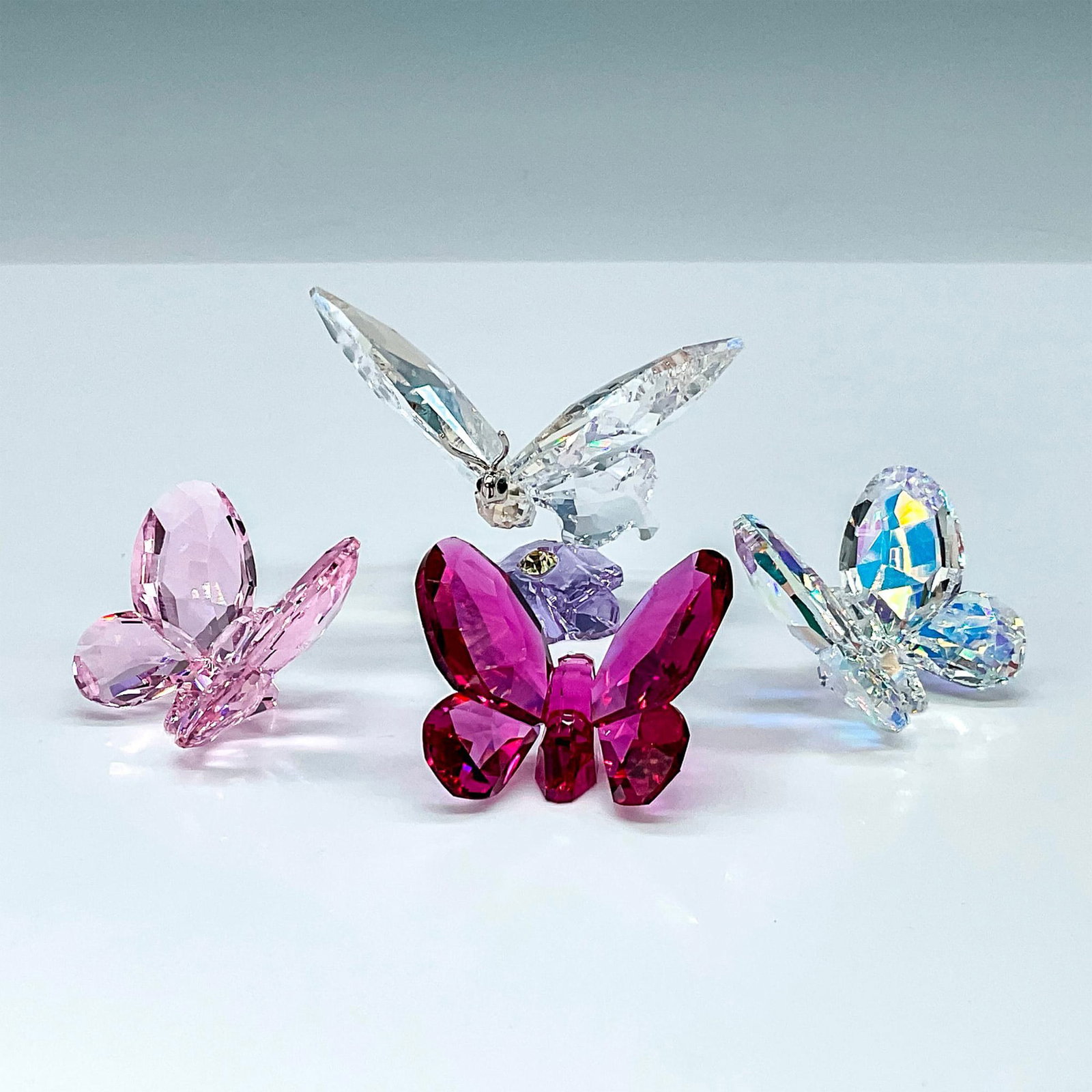 4pc Swarovski Crystal Figurines, Butterfly Grouping: The Swarovski Crystal Butterfly Grouping features the 2013 SCS exclusive Event Butterfly and a set of three butterflies in pink, red, and clear. The SCS butterfly, a true-to-nature interpretation of a