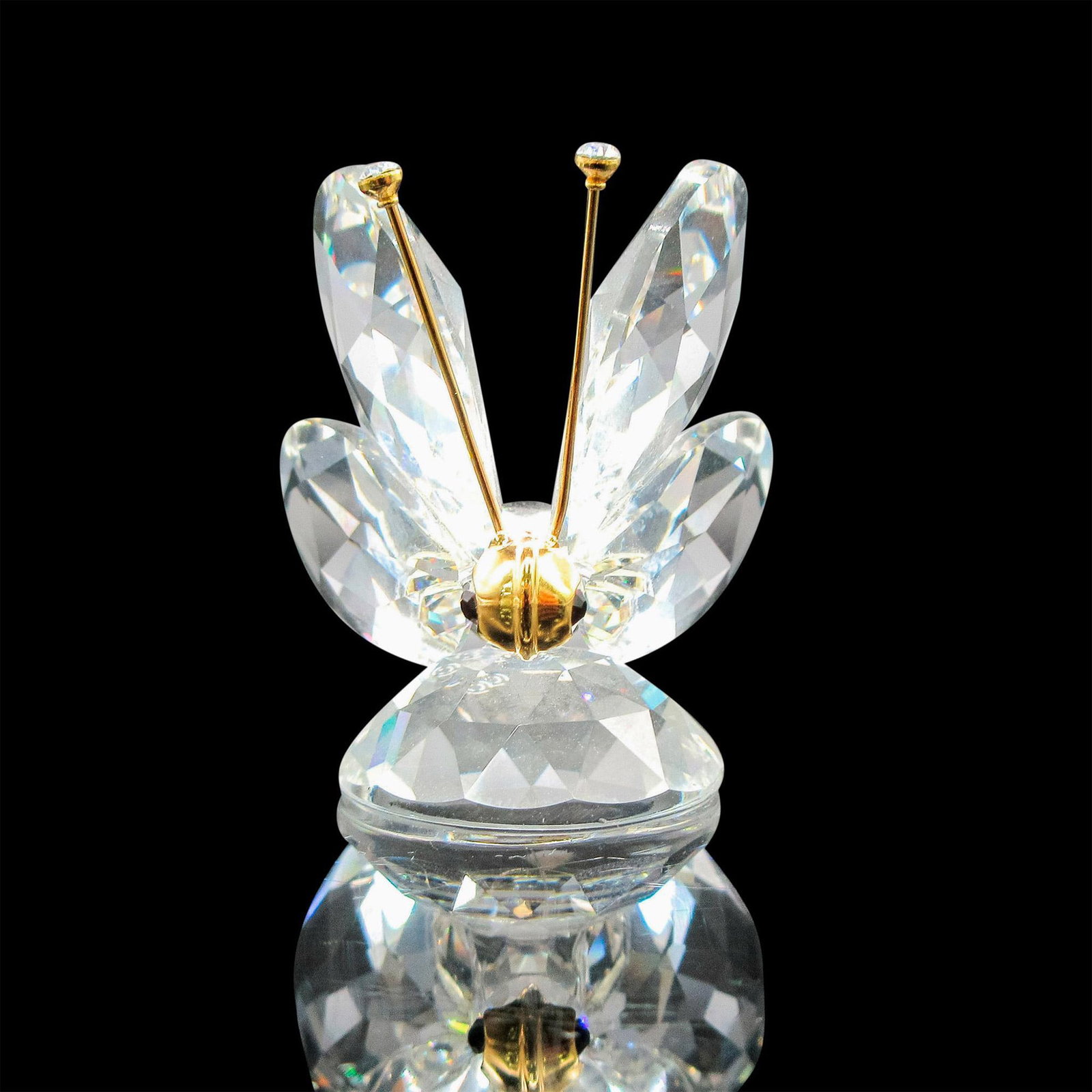 Butterfly Mini - Swarovski Crystal Figurine: Figural is 2nd version created with gold antenna, black eyes, and clear crystal antenna tips. Swarovski backstamp. Artist: Swarovski Team Issued: 1985 - 1988 Dimensions: 1.25"L x 1.25"W x 1.25"H Manuf