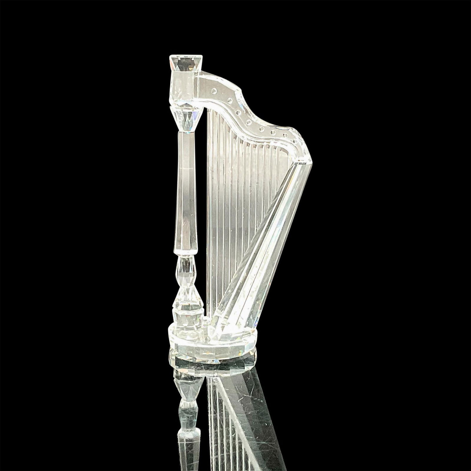 Swarovski Silver Crystal Figurine, Harp: This lovely crystal harp was part of the Crystal Melodies collection and is made from clear crystal. Swarovski etched backstamp. This item has its original box which measures 5"H x 5"dia. Artist: Mart