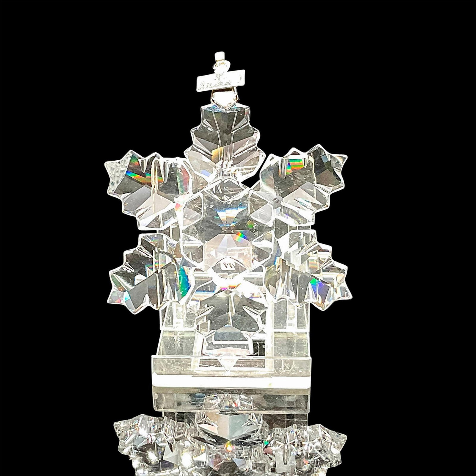 Swarovski Crystal Holiday Ornament, Snowflake 1996: Clear faceted crystal annual ornament created with thicker flake design. Blue satin ribbon included for hanging. Swarovski backstamp. 9445 960 001. This item has its original box: 6"L x 6"W x 1"H. Iss