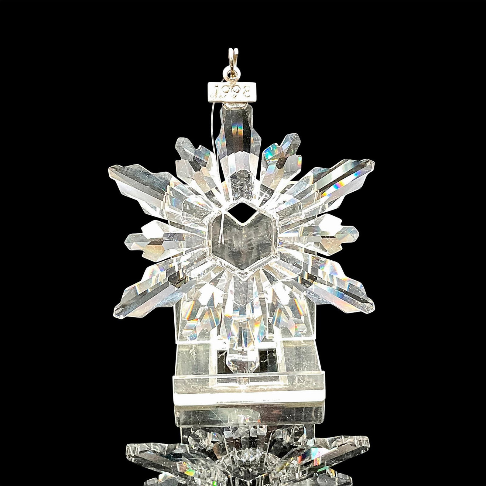 Swarovski Crystal Holiday Ornament, Snowflake 1998: Star shaped crystal snowflake designed for annual ornament, created with 12-points. Blue satin ribbon included for hanging. Swarovski backstamp. 9445 980 001. This item has its original box: 6"L x 6"W