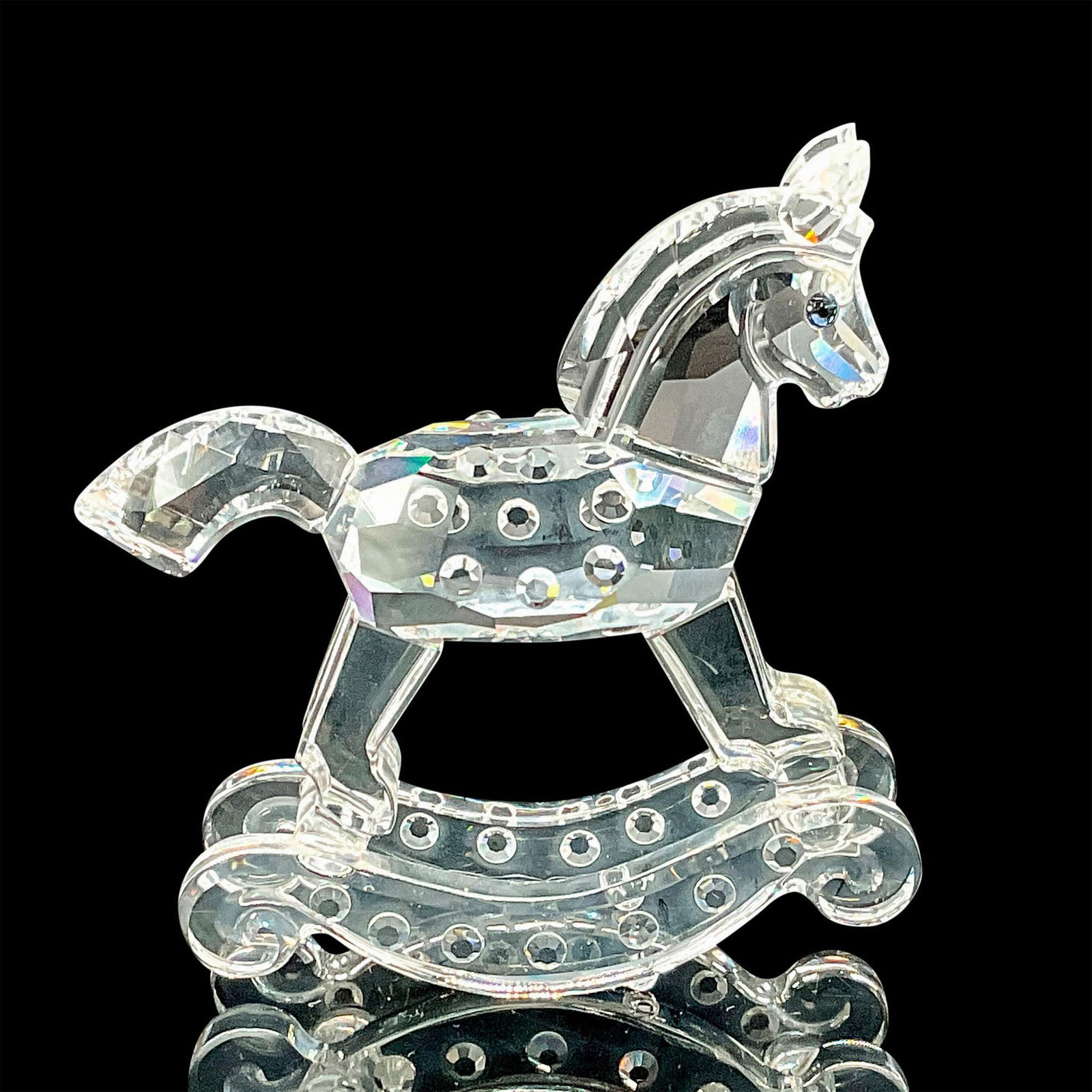 Swarovski Silver Crystal Figurine, Rocking Horse: Sparkling faceted and molded crystal figurine modeled as a tiny rocking horse with blue eyes and gem-like texture details. Swarovski etched backstamp. This item has its original box which measures 4"H