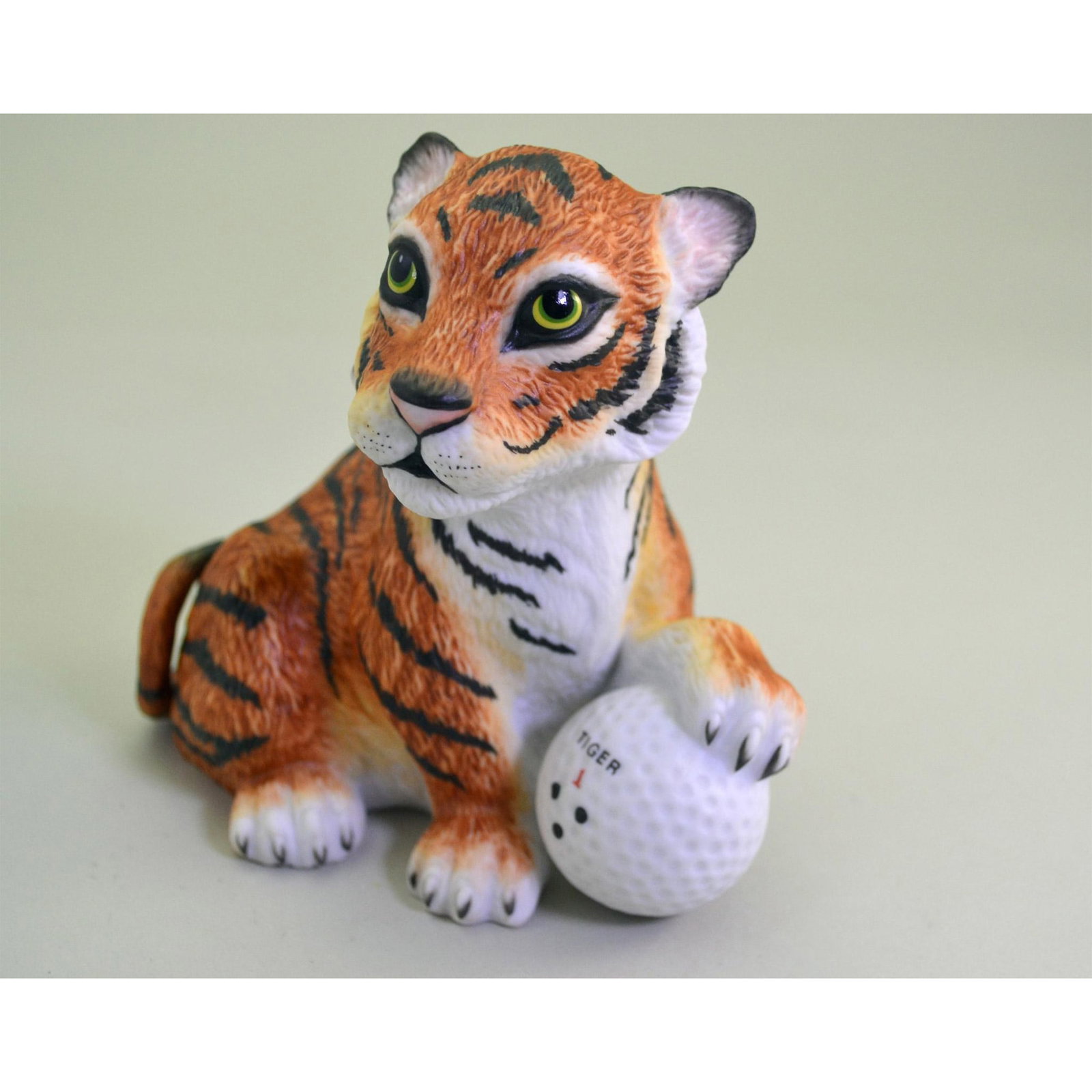 Boehm Porcelain Tiger Woods On The 18Th Hole Figurine: Bisque Porcelain Decorated, hand created, hand painted by the Boehm Artisans. Issued: 1998. Hallmark: SP190. Signed in Script- Tiger Woods for the Tiger Woods Foundation. Size: 5"h x 5"w x 3.50"d. Art