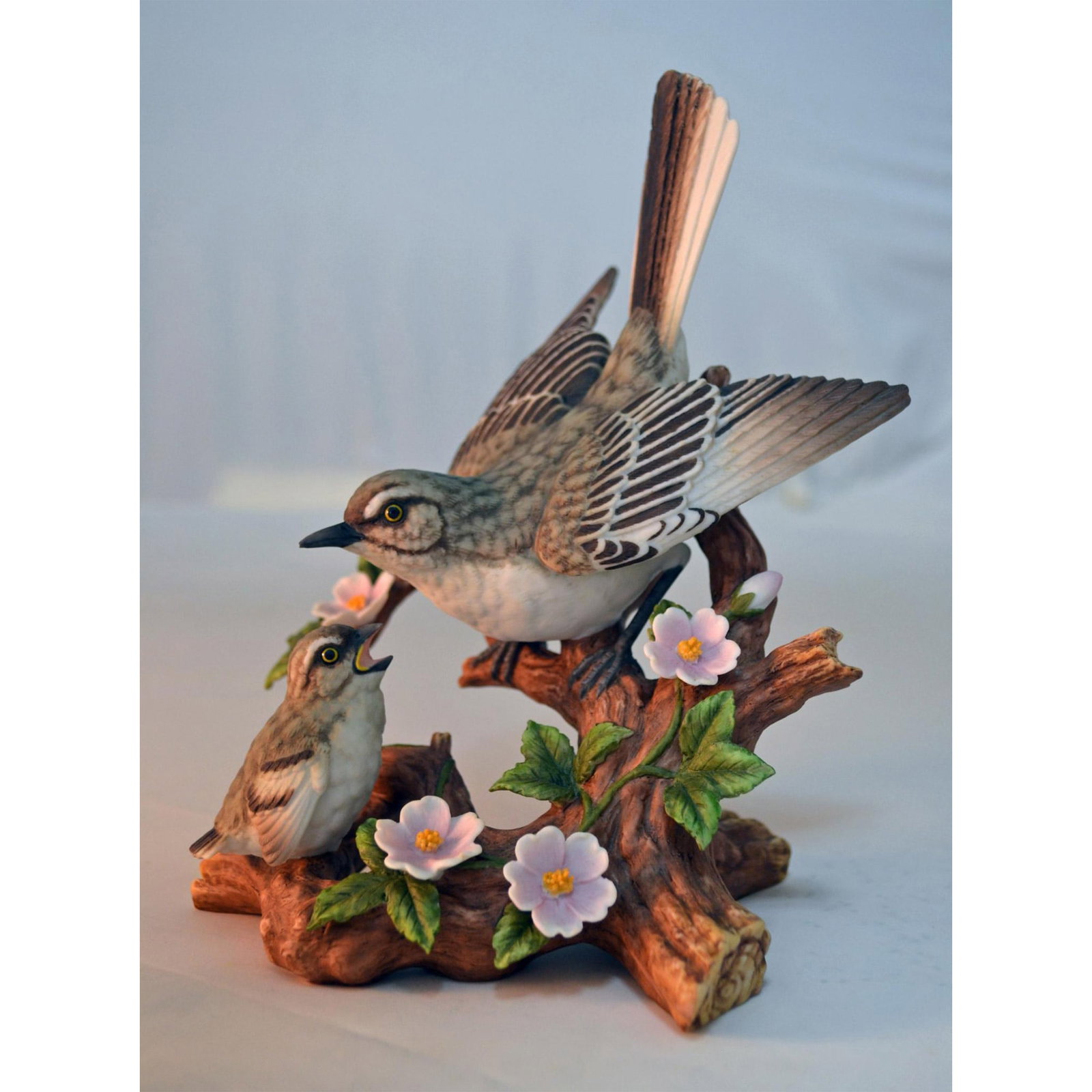 Porcelain Mockingbird With Young Figurine: Bisque Porcelain Decorated, hand created, hand painted featuring an Adult Mockingbird with Young. Issued: 2000. Malaysia. Hallmark: #1. Size: 7"h x 6"w x 5"d. Artist: MARURI Issued: 2000 Dimensions: I