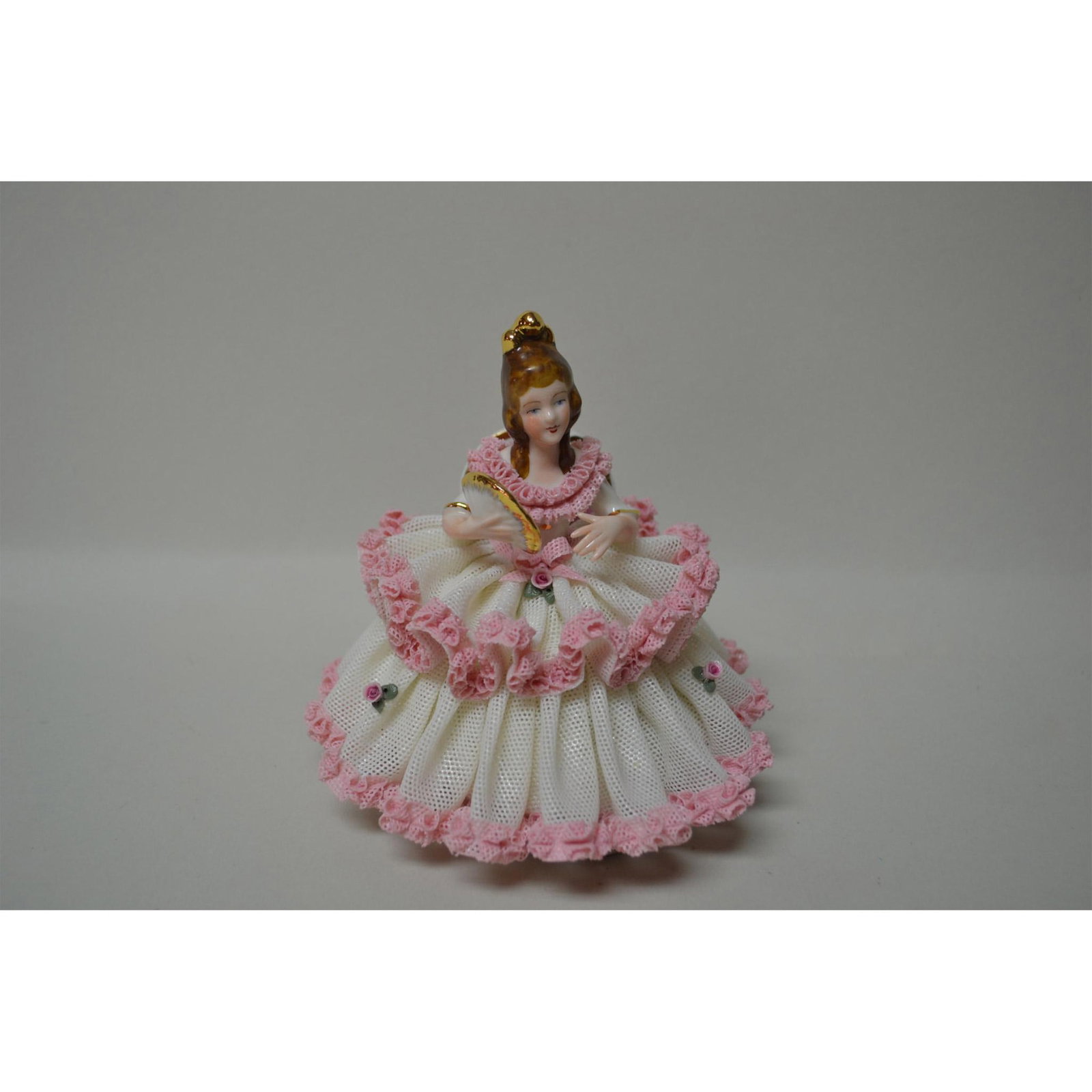 Dresden Porcelain Lace Doll Figurine In Pink And White, Vintage: Pink and White Lace Porcelain, Dresden Germany, early 1900's. Figurine is seated in a chair holding a fan. Hallmark : Bottom, see photos for reference. Size: 5.5"h x 5.5"w x 4"d. Artist: DRESDEN Issue