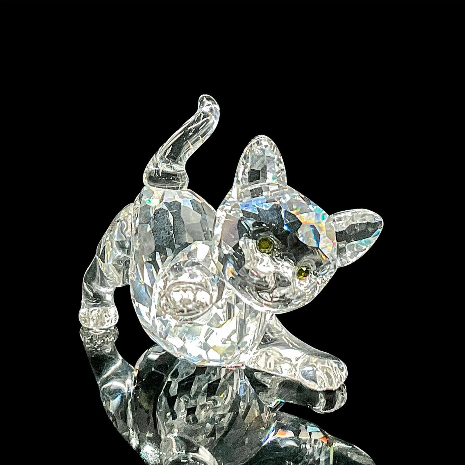 Swarovski Silver Crystal Figurine, Playful Kitten: Clear faceted crystal figure of a little kitten with green crystal eyes. Item number 7619NR000011. Swarovski etched backstamp. This item has its original box 2.5"H x 3.25"dia. Issued: 2004 - 2012 Dime