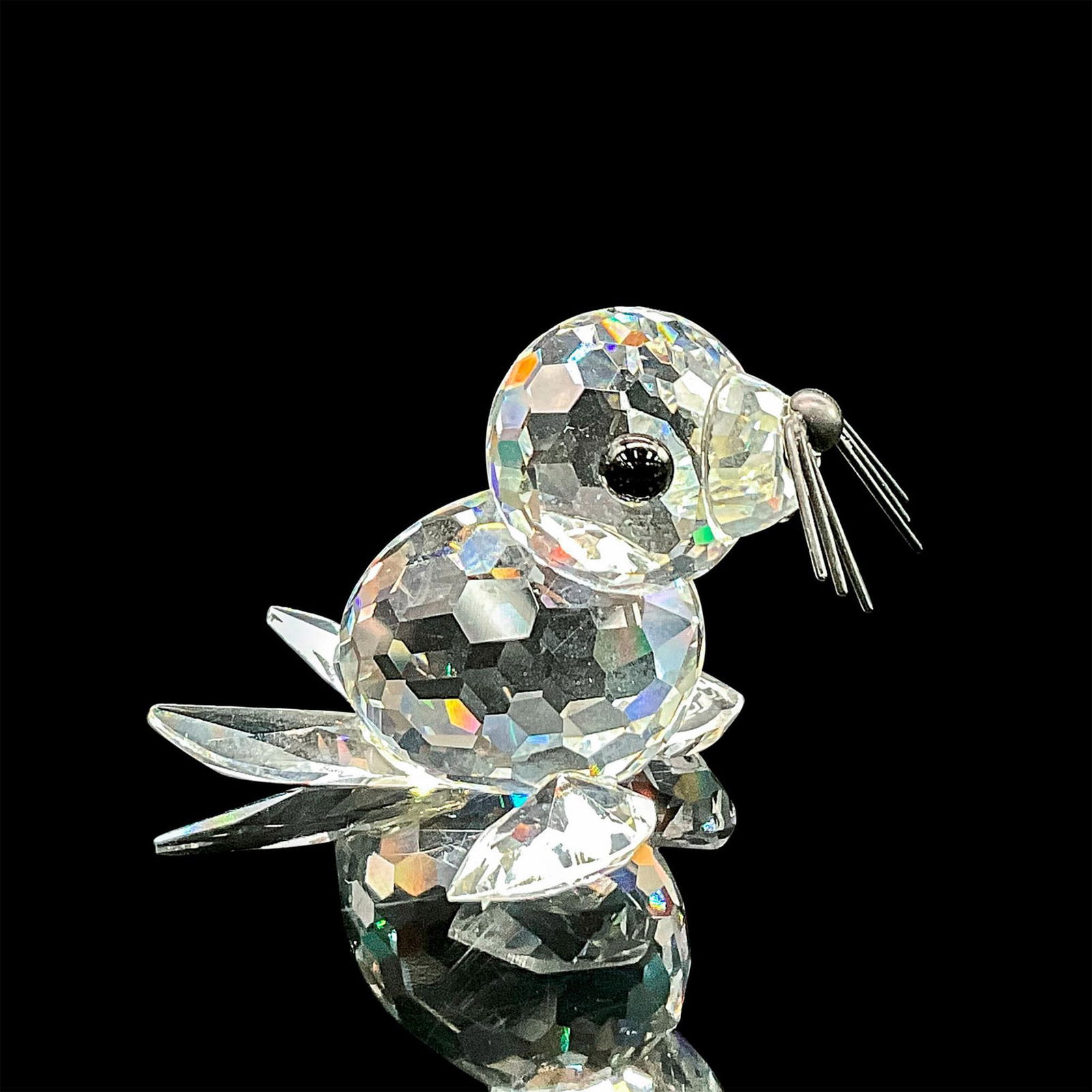 Swarovski Silver Crystal Figurine, Seal: Clear faceted crystal figure of a seal with black eyes, nose and metal whiskers. Part of the Kingdom of Ice and Snow collection. Item number 7663NR046000. Swarovski etched mark. This item has its orig