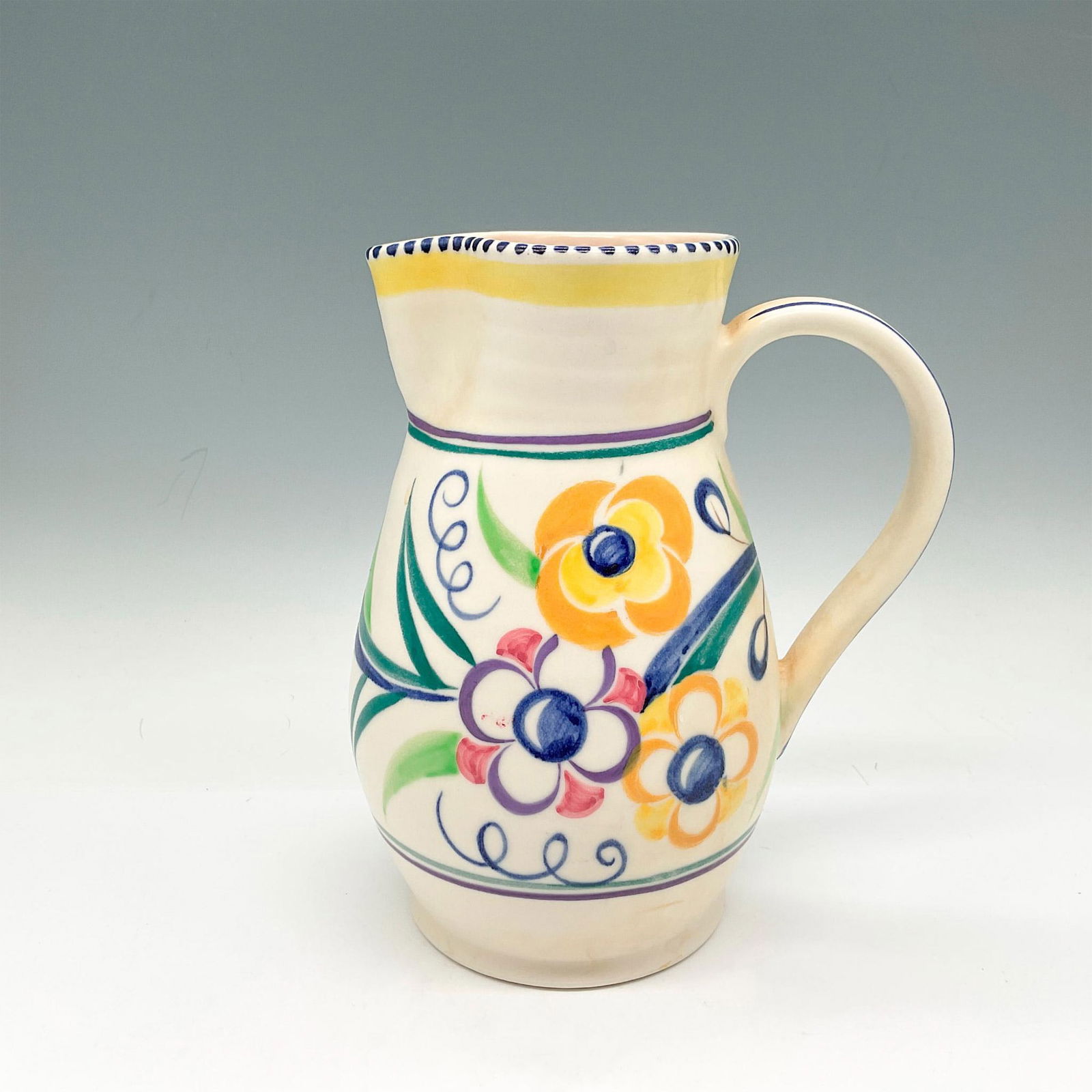 Poole Pottery Traditional Ware, LE Pattern: Delicate floral patterned pitcher, colored in vibrant purple, blue, yellow and green. Painted by Sylvia Penney. Poole backstamp. 549 impressed mark. Issued: c. 1960 Dimensions: 6"L x 4.5"W x 7.25"H Ma