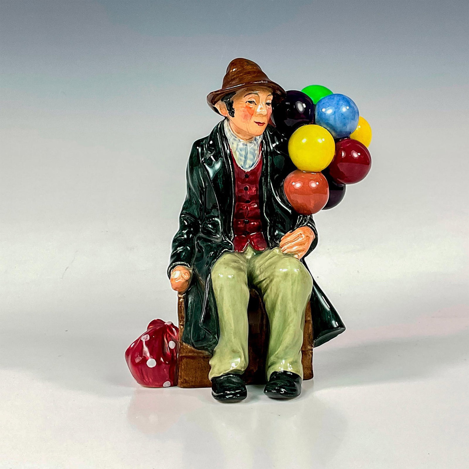 Balloon Man - HN1954 - Royal Doulton Figurine: Glaze finish; Royal Doulton backstamp. Artist: Leslie Harradine Issued: 1940 - 2009 Dimensions: 7.25"H Manufacturer: Royal Doulton Country of Origin: England