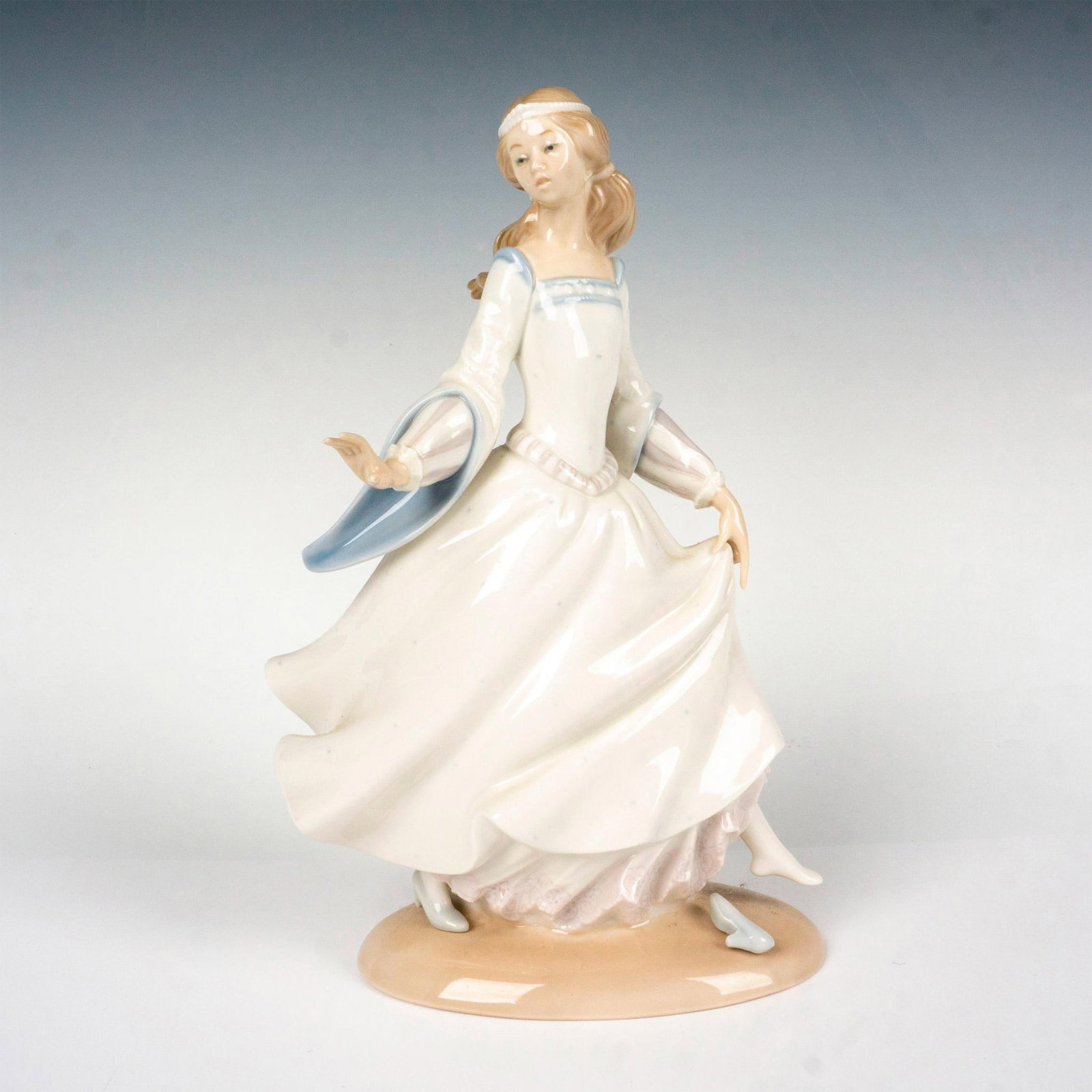 Cinderella 1004828 - Lladro Porcelain Figurine: Glossy finish; Lladro backstamp. Includes original box. Box measures 12.5"L x 7.5"W x 6"H. Artist: Alfredo Ruiz Issued: 1972 - 1998 Dimensions: 9.75"H x 6"W Manufacturer: Lladro Country of Origin: