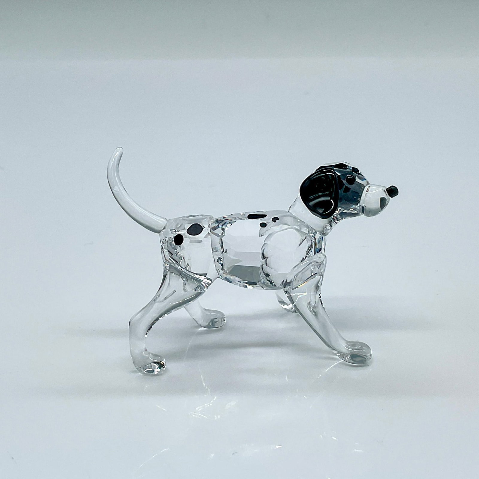 Swarovski Crystal Figurine, Dalmatian Puppy Standing: Part of The Peaceful Countryside collection. A clear crystal puppy with black ears, eyes, nose, and spots. Swarovski marked. This item has its original box: 3.25"W x 4.75"H. Artist: Edith Mair Issued: