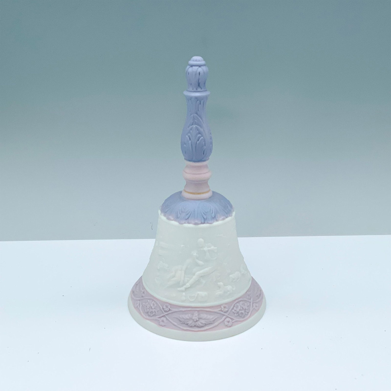 Eternal Love Bell 1017542 - Lladro Porcelain: Matte finish; Lladro backstamp. Box measures: 6"L x 5"W x 11"H. Artist: Design & Decoration Dept. Issued: 1994 - 1994 Dimensions: 7.25"H Manufacturer: Lladro Country of Origin: Spain