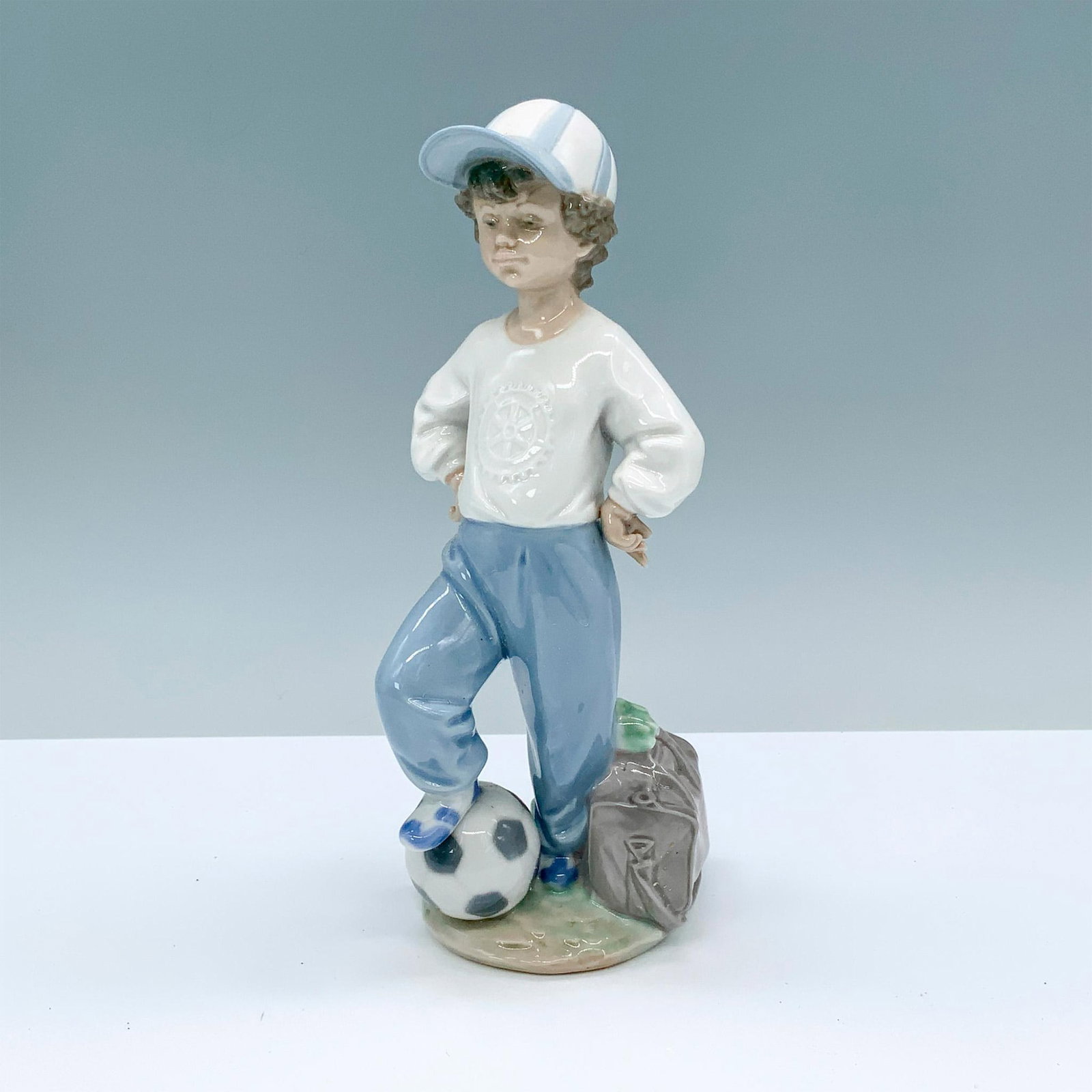 Starting Forward 1007605 - Lladro Porcelain Figurine: Glossy finish; Lladro backstamp. Artist signature. Box measures: 12.75"L x 7.25"W x 6.25"H. Artist: Antonio Ramos Issued: 1989 - 2004 Dimensions: 8.75"H x 3.25"W Manufacturer: Lladro Country of Or