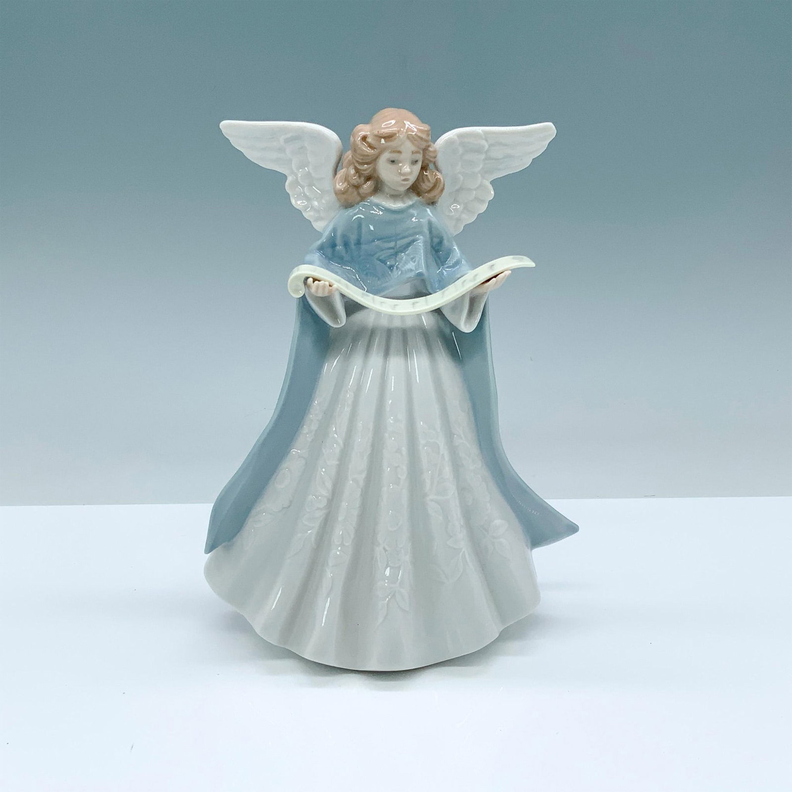 Blue Tree Topper 1005719 - 1990 Lladro Porcelain: Glossy finish; Lladro backstamp. Box measures: 8"L x 6"W x 12.75"H. Artist: Francisco Catala Issued: 1990 - 1990 Dimensions: 7"H Manufacturer: Lladro Country of Origin: Spain