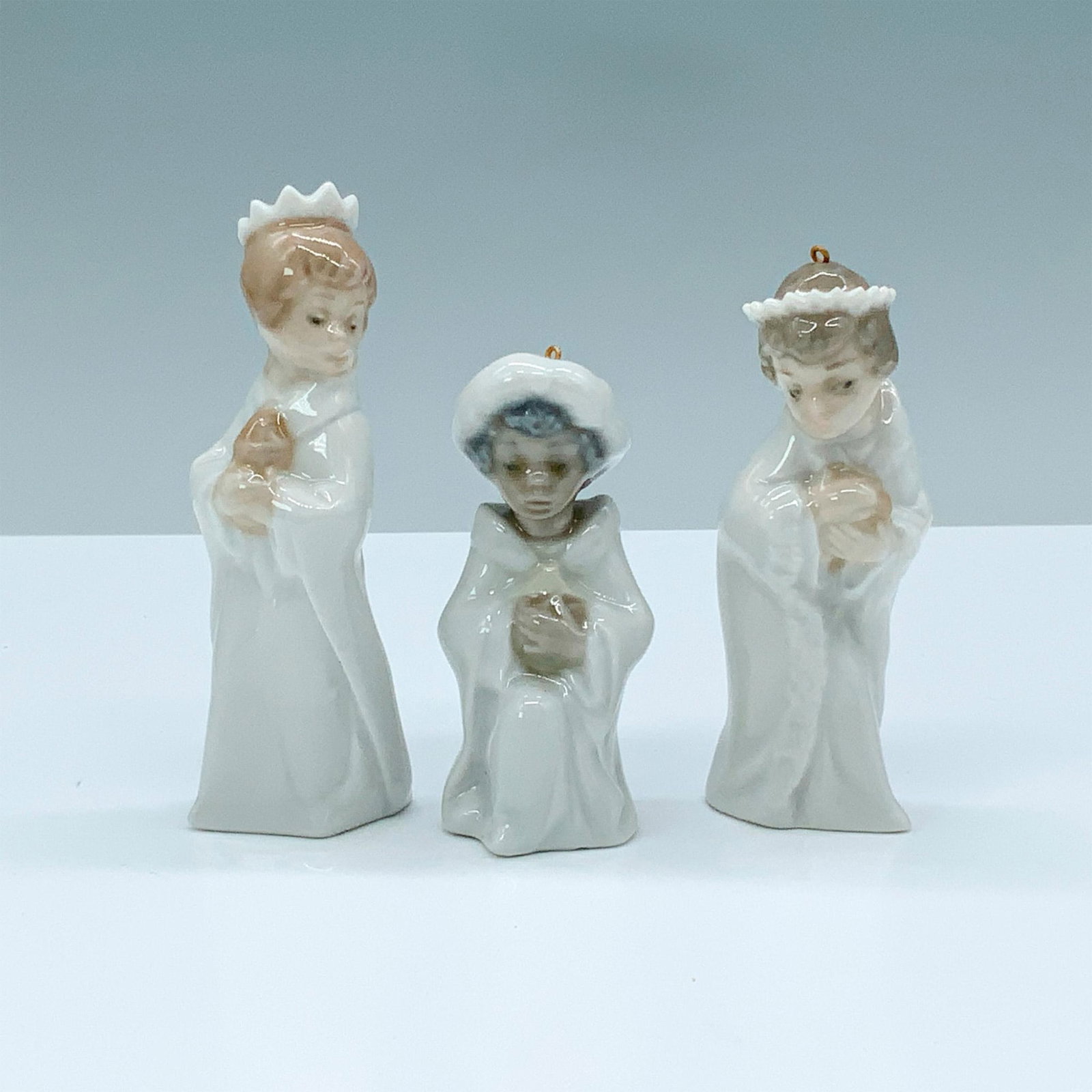 Three Kings 1005729 - Lladro Porcelain Figurine: Glossy finish; Lladro backstamp. Box measures: 7.5"L x 5"W x 3"H. Artist: Francisco Polope Issued: 1990 - 1990 Dimensions: 4.25"H Manufacturer: Lladro Country of Origin: Spain