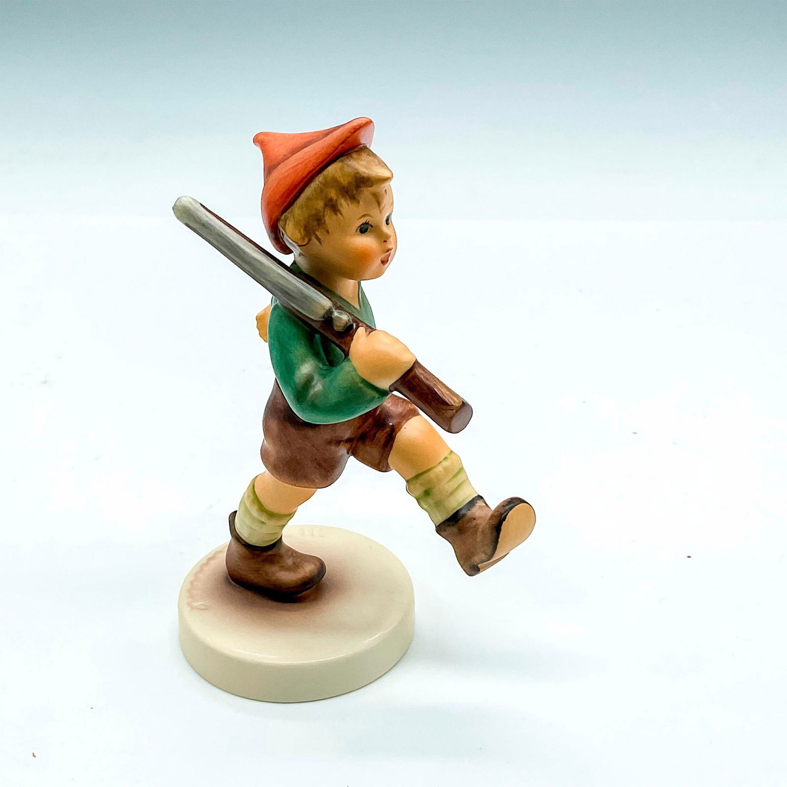 Goebel Hummel Porcelain Figurine, On Parade: Hand painted boy with red cap and rifle. Goebel Germany backstamp. Impress mark 720. Issued: 2004 Dimensions: 3.25"L x 2"W x 5"H Manufacturer: Goebel Hummel Country of Origin: Germany