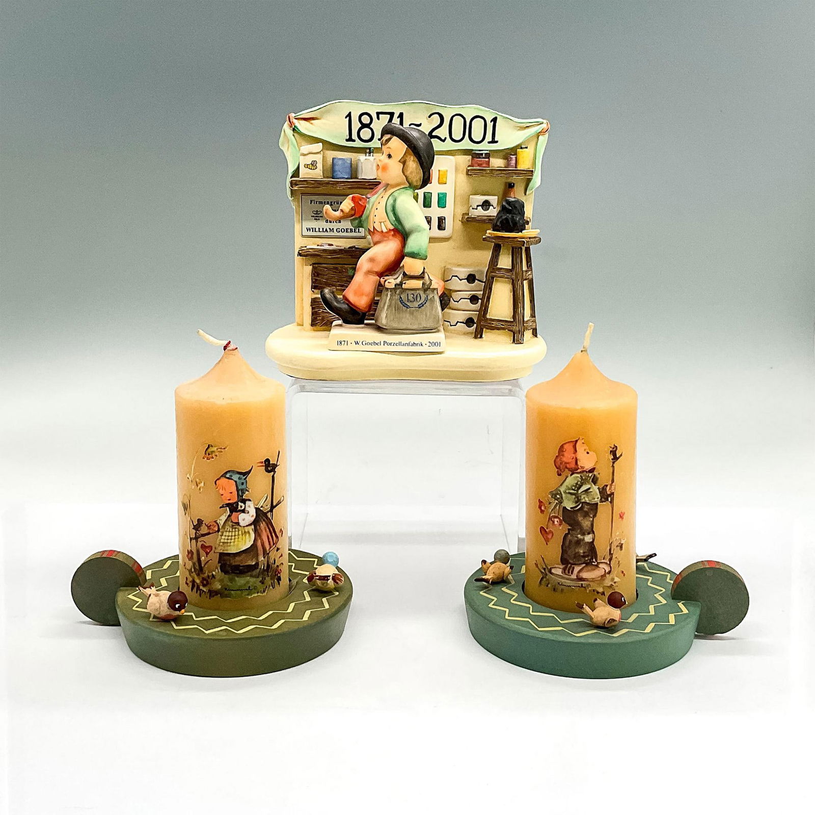 6pc Goebel Hummel Figurine/Figural/Candles With Holders: Two whimsical Anri wood bird candle holders 5"L x 4"W x 1.25"H with two Hummel wax candles 4.75"H x 2" dia. Goebel 130th Anniversary Generations Of Excellence resin figural of a workstation with detai