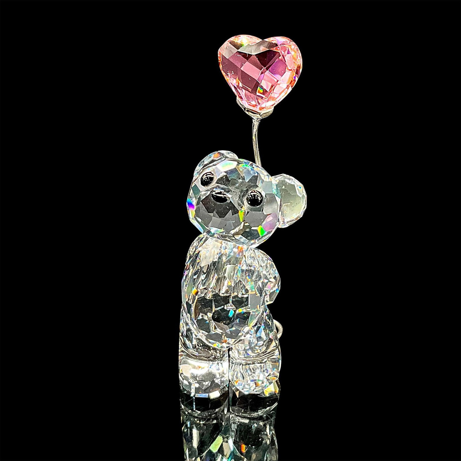Swarovski Crystal Figurine, Kris Bear, I Love You: Clear faceted crystal figure modelled as sweet little Kris Bear holding a pink crystal heart shaped balloon. Part of the With Love collection. Swarovski mark. 842933. This item has its original box: 4