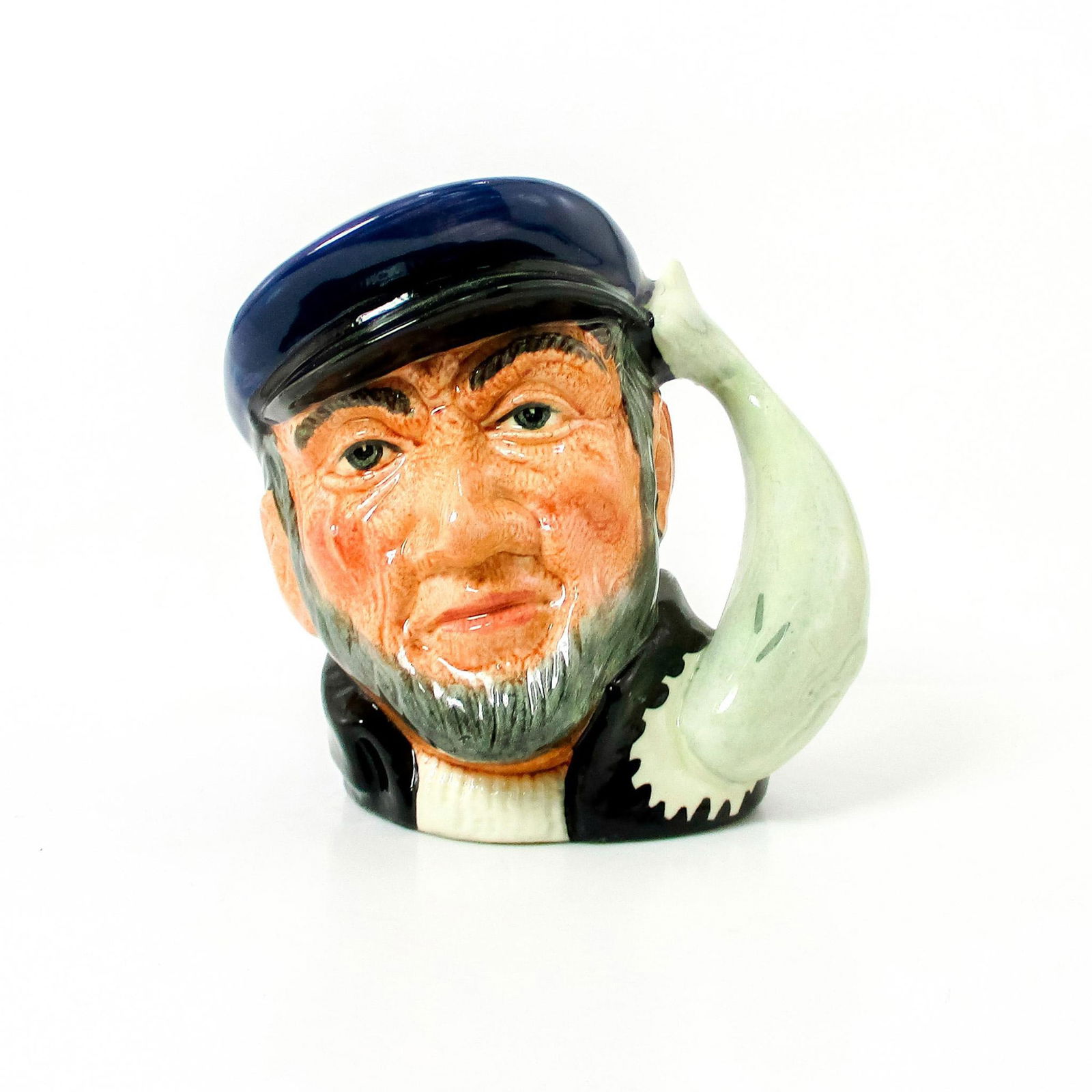 Captain Ahab D6506 - Small - Royal Doulton Character Jug: Blue cap; black coat; white sweater. Captain Ahab sailed the whaler, Pequod, in Herman Melville's great 19th century American classic, "Moby Dick". He lost a leg and then his life in pursuit of the gr
