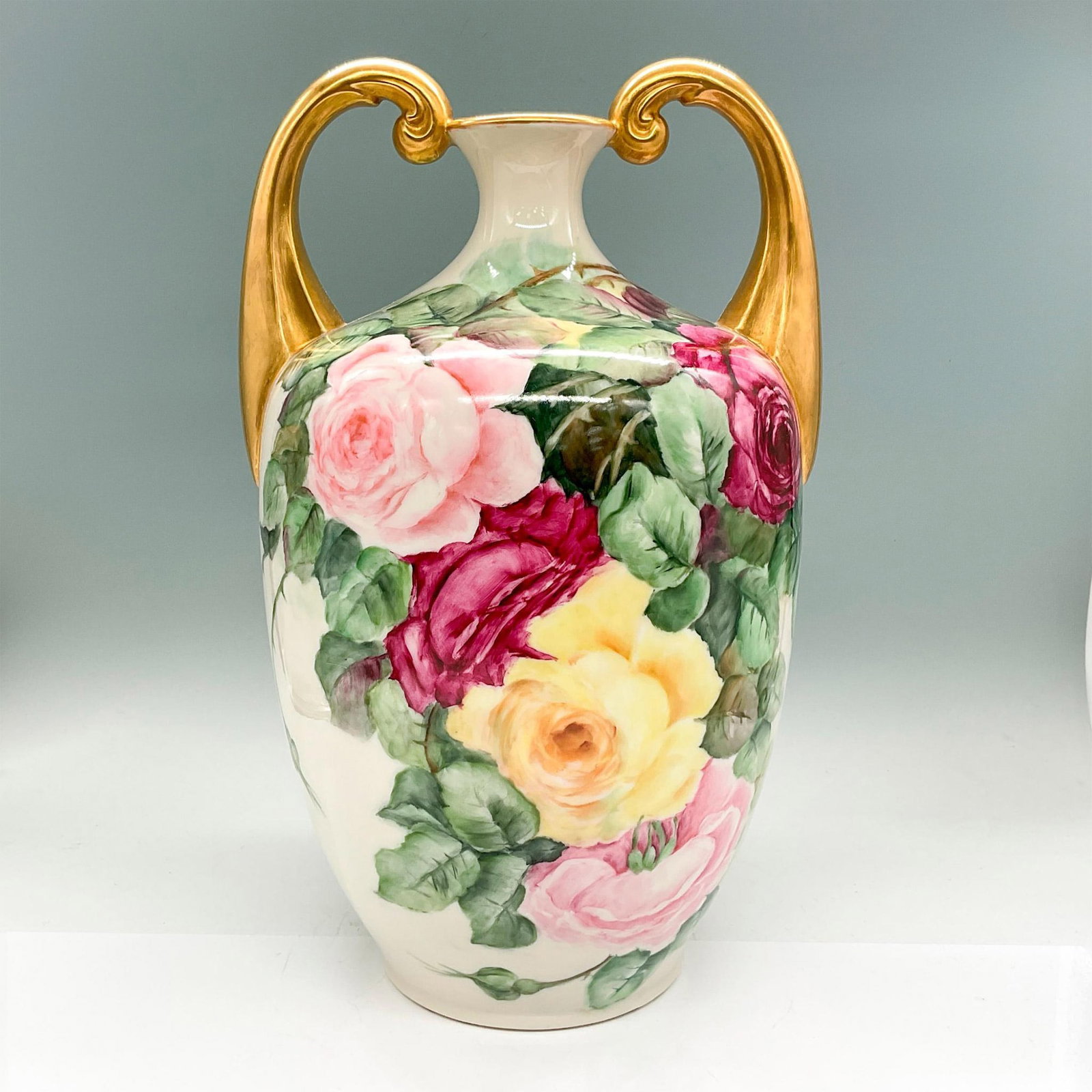 Lenox Belleek Porcelain Amphora Vase, Roses: Tall vase with hand painted magenta, yellow and pink roses, green leaves; gold handles and rim. Lenox Belleek backstamp. Issued: 1889-1906 Dimensions: 8.75"L x 7.5"W x 13.5"H Manufacturer: Lenox Belle