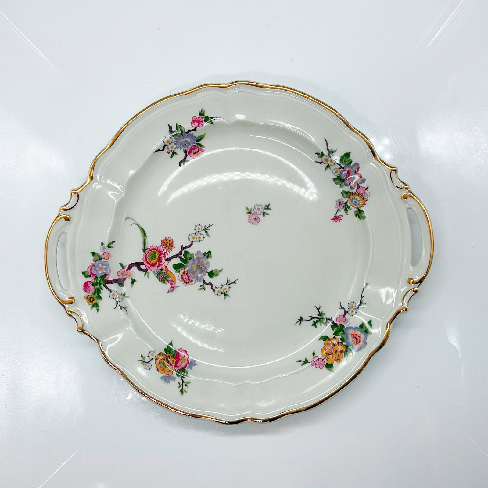 Bernardoud Limoges Porcelain Decorative Tray: Ivory tray with scalloped gilded edge and multi-floral motif. Backstamped Bernardoud Limoges France Bengali 52. Issued: 20th century Dimensions: 1"H x 11.5"dia Manufacturer: Bernardaud Country of Orig