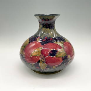 Moorcroft Burslem Pottery Vase, Pomegranate: Green base color with raised colorful pomegranate and leaf design. Blue interior color. Signed by artist. Moorcroft Burslem England impressed mark. 2265. Artist: William Moorcroft Issued: c. 1928