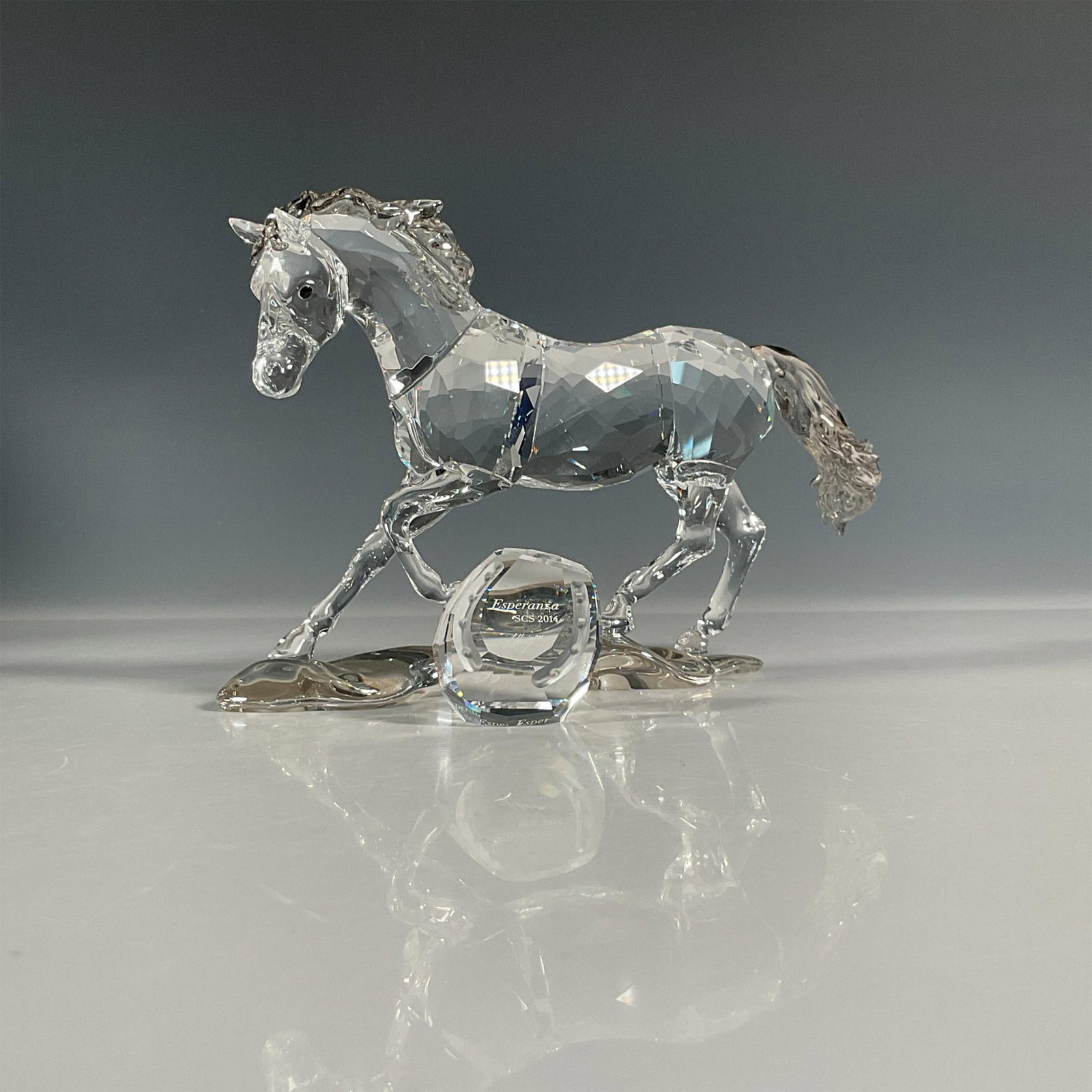 Swarovski Crystal Figurine with Plaque, Esperanza: Annual edition piece made from clear crystal with satin crystal mane and tail. Plaque is engraved with figure title and artist signature. Piece comes with a pair of handling gloves. Swarovski etched b