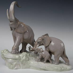 Elephants 1001150 - Lladro Porcelain Sculpture: This figurine features a family of three elephants a mother, father, and calf gracefully traversing a grassy plain. Lladro backstamp. Artist: Fulgencio Garcia Issued: 20th century Dimensions: 16"L x 8