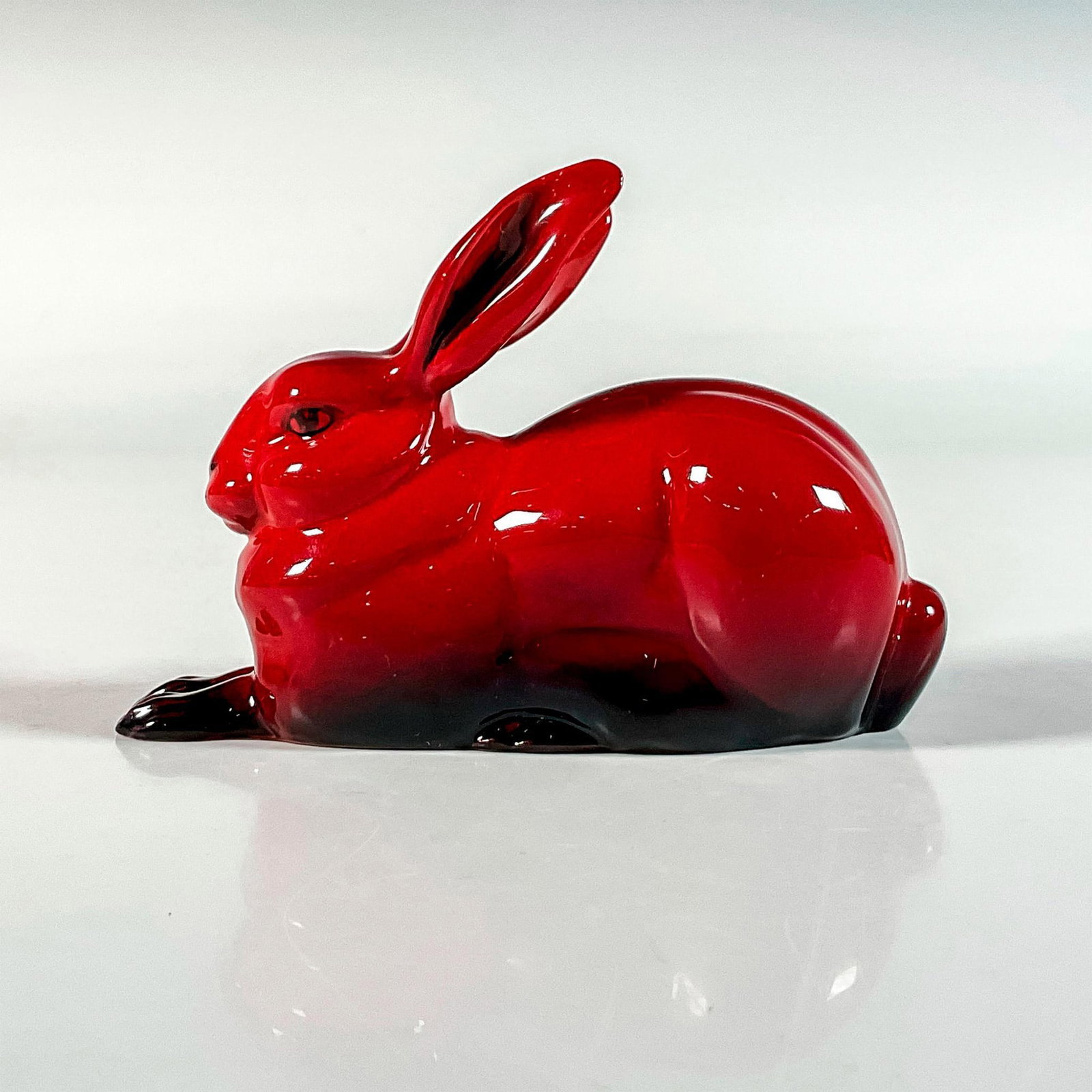 Hare Crouching HN2592 Flambe - Royal Doulton Figurine: Rich red glaze animal study depicting a hare on all fours. Flambe backstamp. Royal Doulton backstamp. Issued: 1945-1996 Dimensions: 1.5"L x 4.25"W x 3"H Manufacturer: Royal Doulton Country of Origin: 