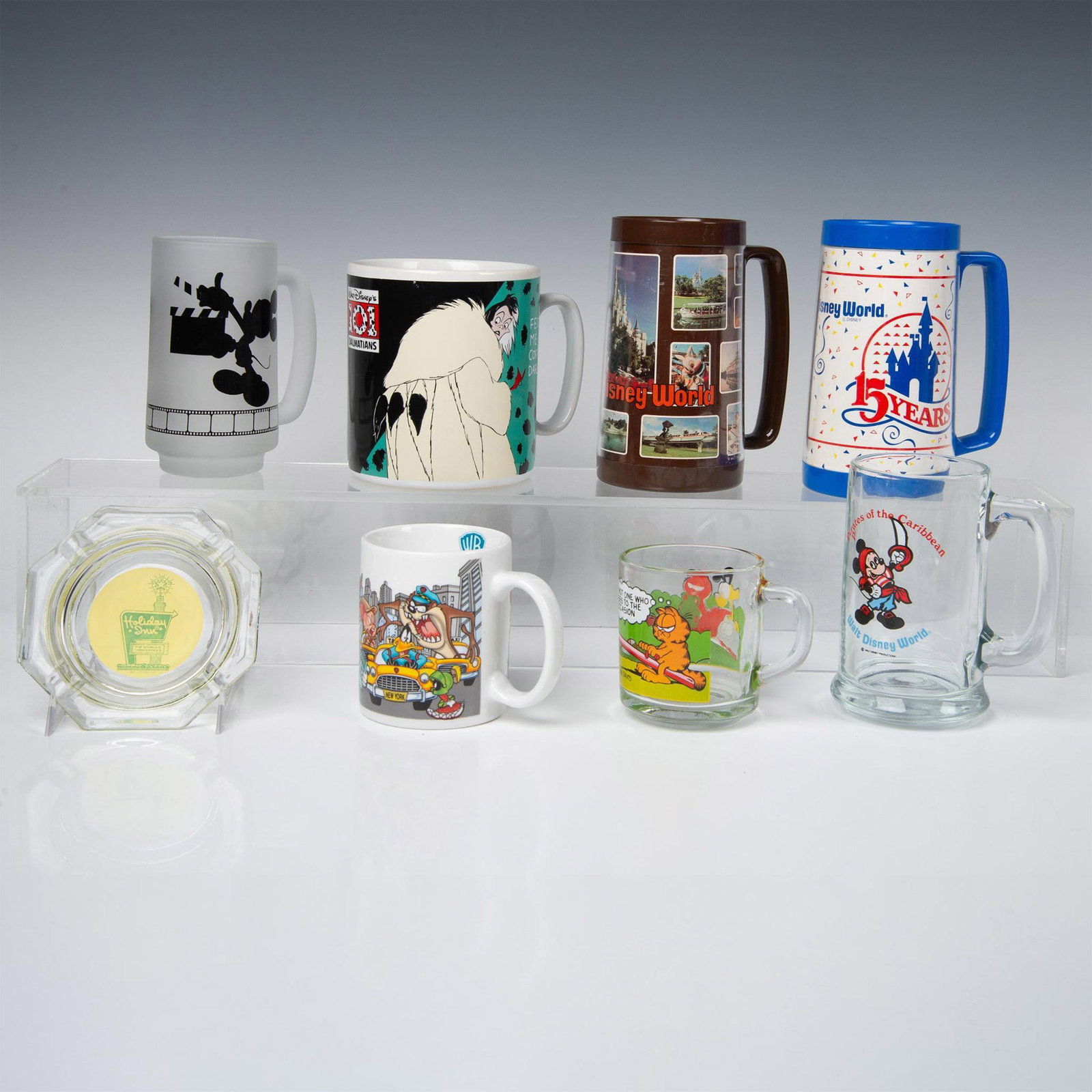 8pc Vintage Promotional Glassware, Disney, WB, McDonald's: This collection features 2 tall plastic Walt Disney World mugs, 2 tall glass Disney mugs, a large 101 Dalmatian ceramic mug, a Warner Brothers Looney Tunes ceramic mug, a Garfield glass mug distribute