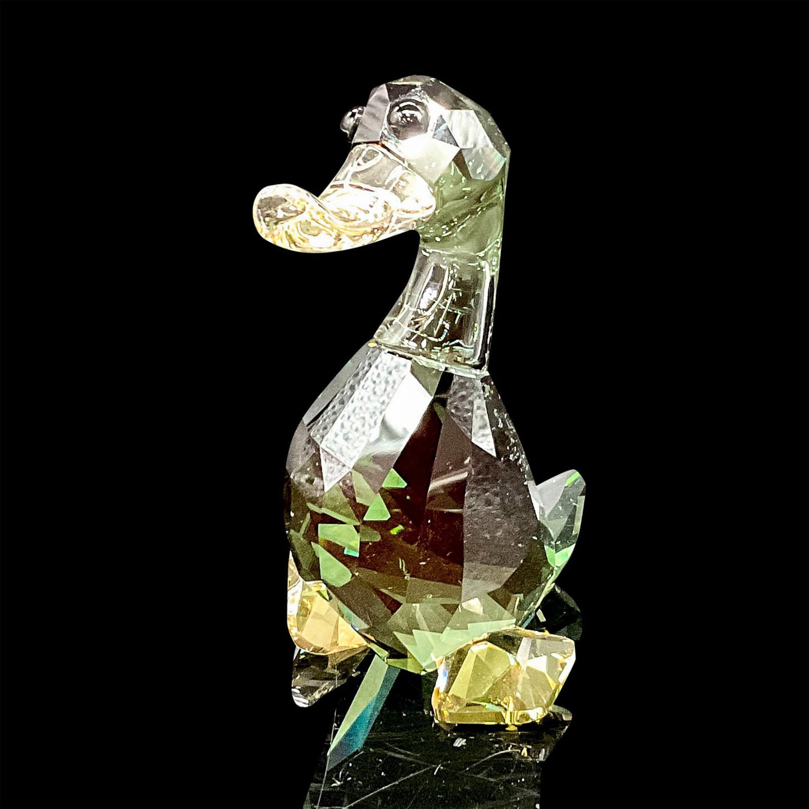 Swarovski Crystal Figurine, The Lovlots Duke: Part of the Lovlots City Park Collection. Adorable figural created in green crystal with amber crystal bill and feet. Black round crystal eyes. Swarovski backstamp. 1041298. This item has its original