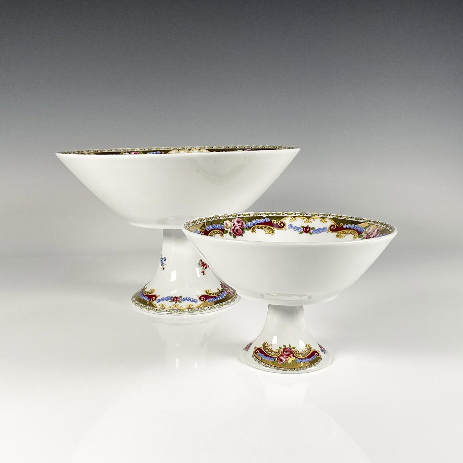 2pc Depose T. Limoges Floral Footed Bowls: Two French Limoges footed bowls of different sizes, decorated with large floral motifs to interior and around the feet with heavy gilt touches. Depos Porcellane Decorate T. Limoges backstamp. Largest 