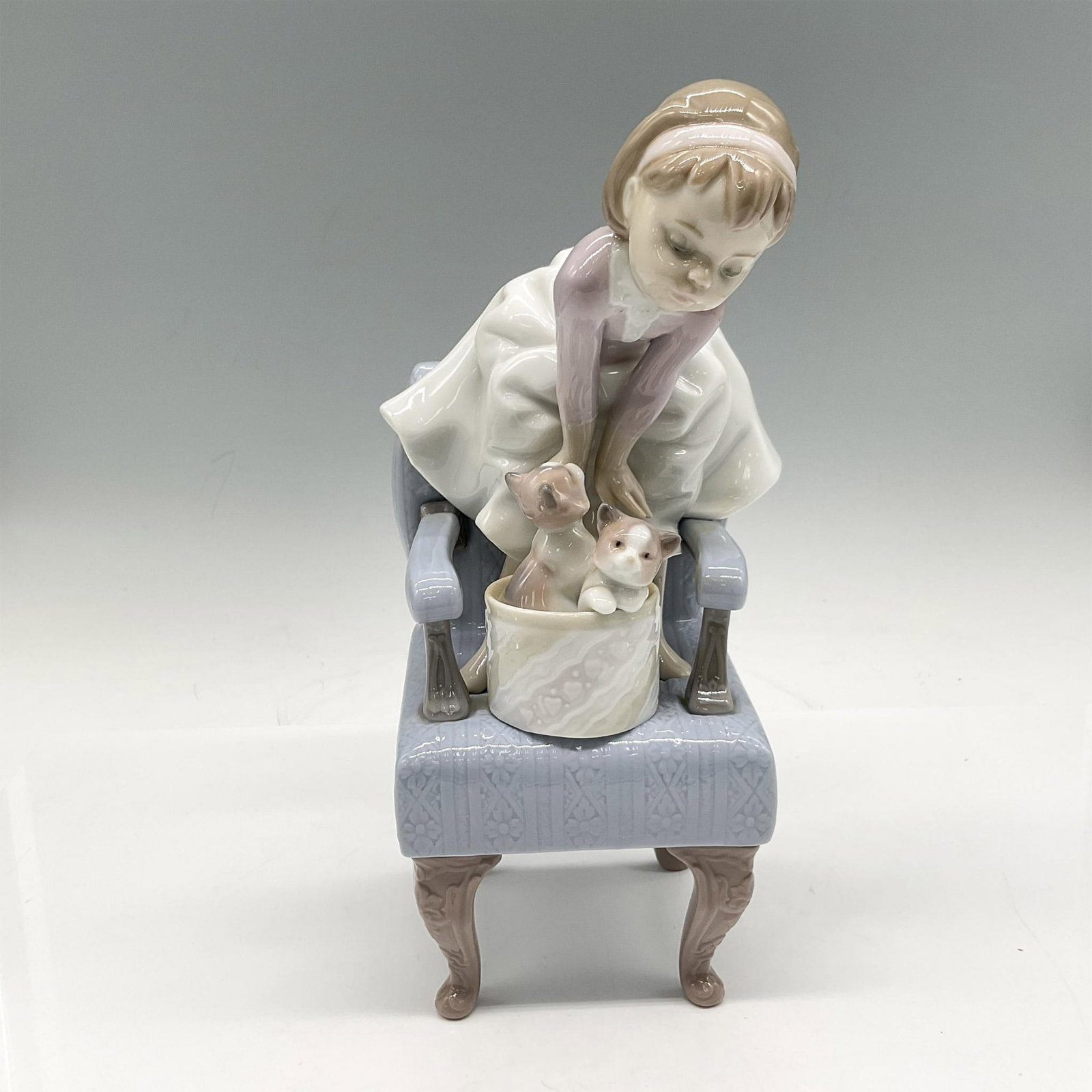 Purr-fect Friends 1006512 - Lladro Porcelain Figurine: 1998 Event Figurine is this adorable figural of a little girl on chair with 2 kittens in basket. Lladro backstamp. Artist: Joan Coderch Issued: 1998 Dimensions: 3.75"L x 3.75"W x 9.5"H Manufacturer: L