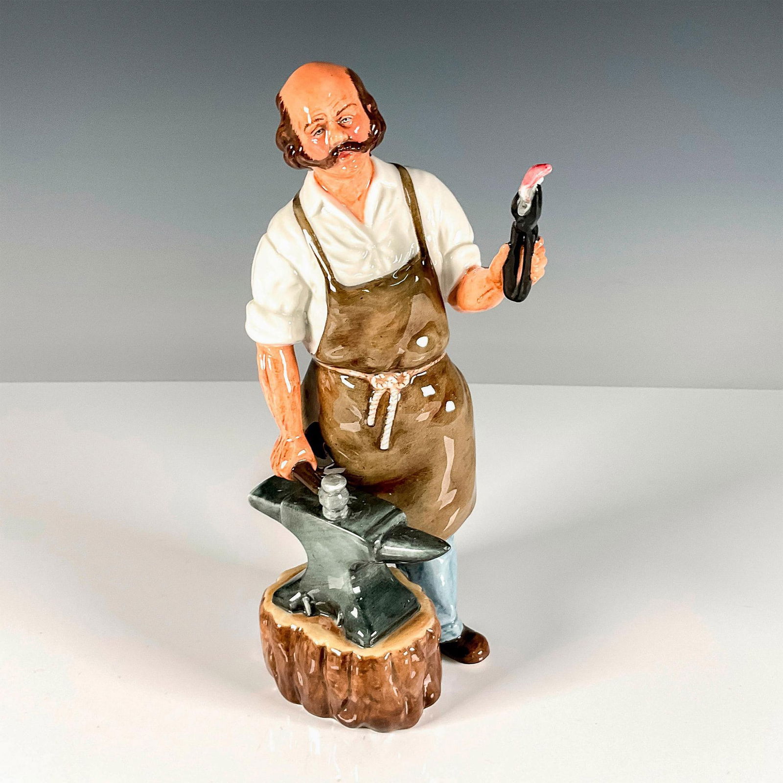 Blacksmith - HN2782 - Royal Doulton Figurine: Artist: William K. Harper Issued: 1987 - 1991 Dimensions: 9"H Manufacturer: Royal Doulton Country of Origin: England