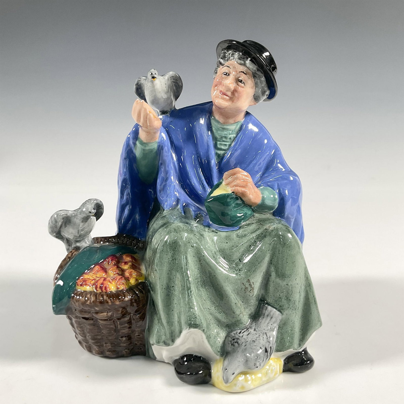 Tuppence A Bag - HN2320 - Royal Doulton Figurine: Artist: Mary Nicoll Issued: 1968 - 1995 Dimensions: 5.5"H Manufacturer: Royal Doulton Country of Origin: England