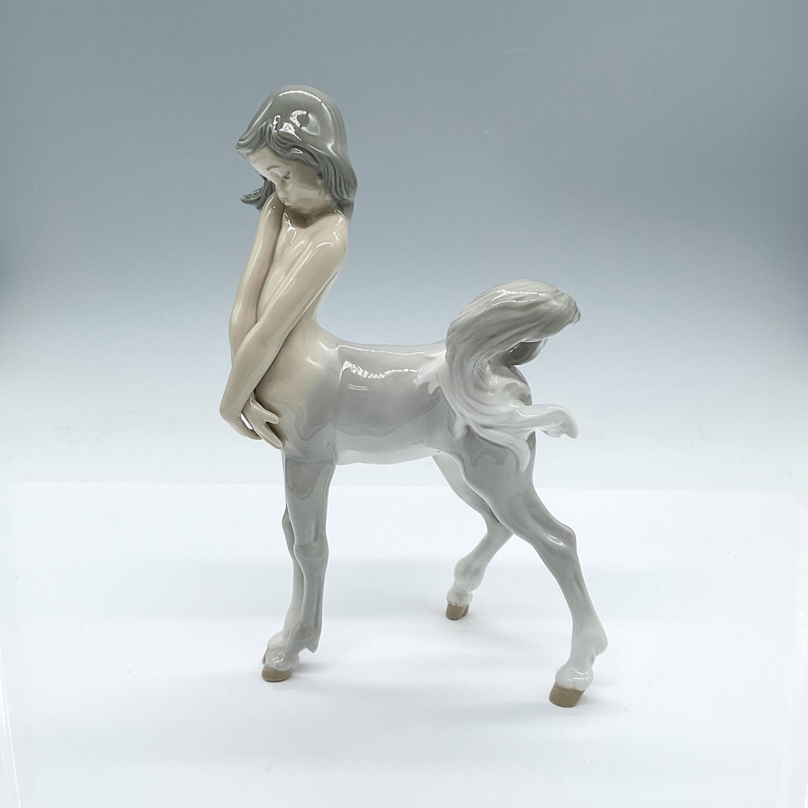 Lladro Porcelain Figurine, Centaur Girl 1001012: This lovely piece is half girl and half horse looking a bit demure. Glossy finish. Lladro backstamp. Artist: Fulgencio Garcia Issued: 1969-1989 Dimensions: 5.75"L x 3.25"W x 9.50"H Manufacturer: Lladr